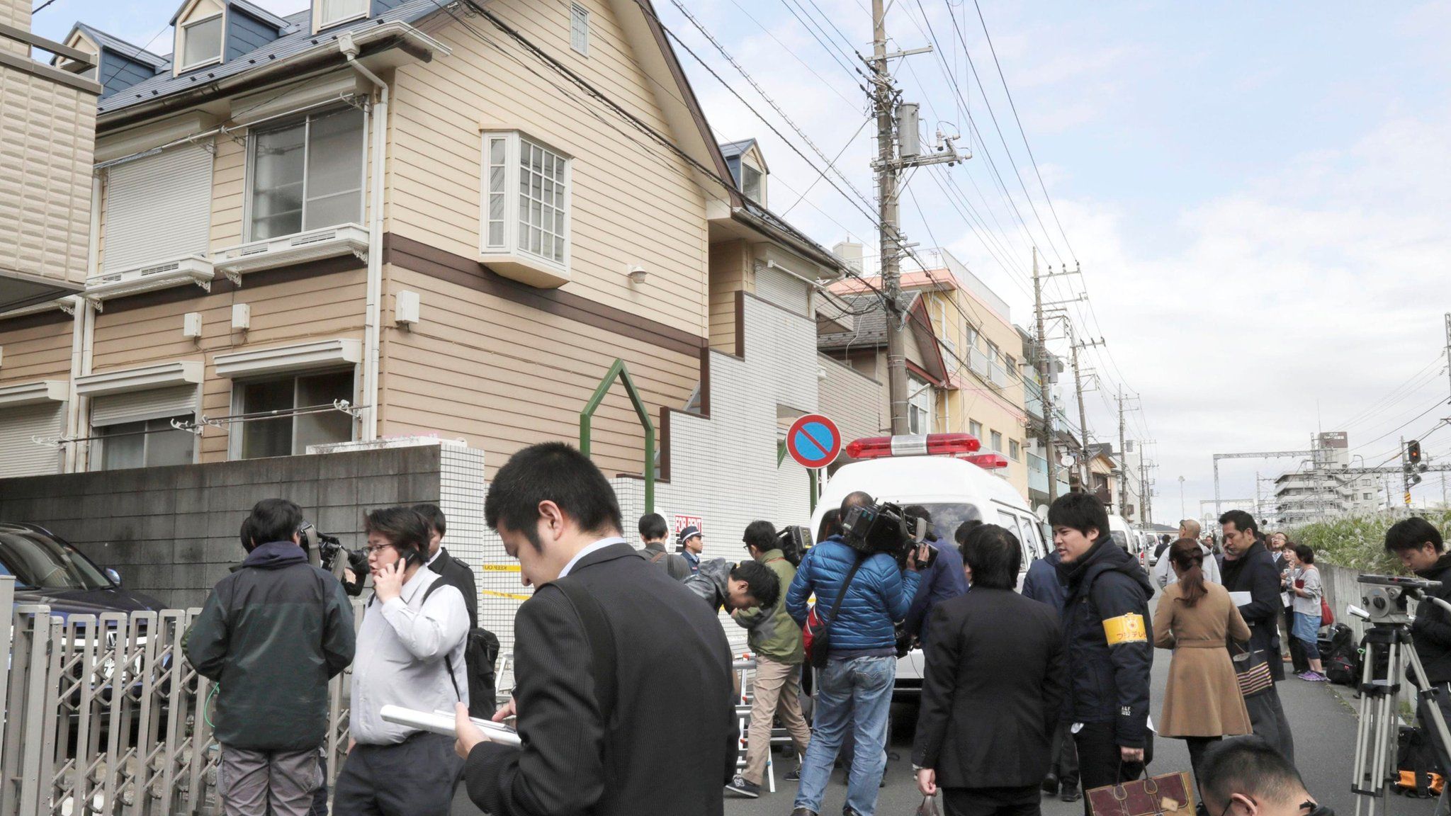Members of the media gather in front of an apartment building where media reported nine bodies were found in Zama, Kanagawa Prefecture, Japan in this photo taken by Kyodo on October 31, 2017