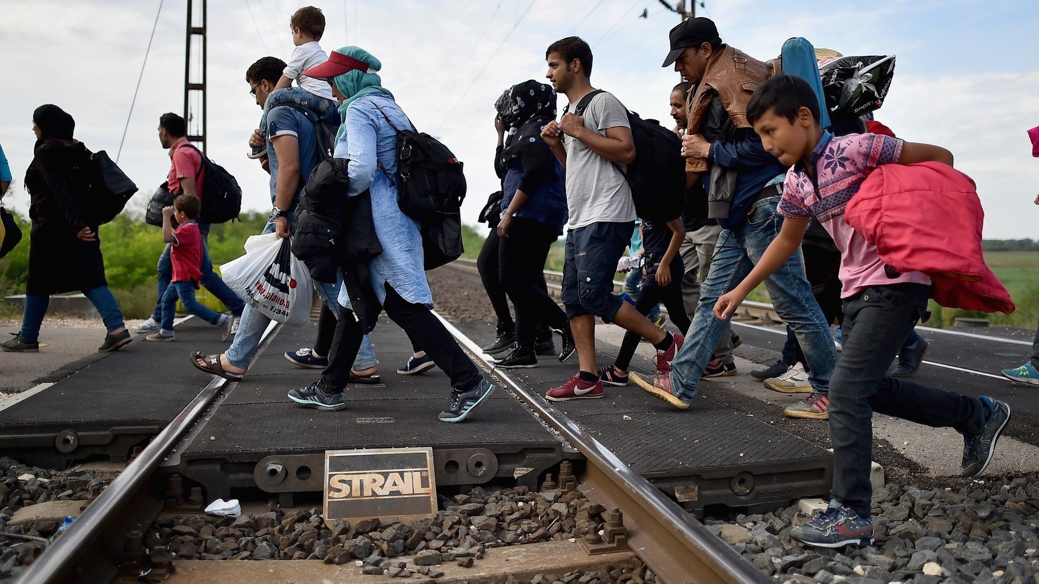 Migrants try to cross from Hungary to Austria in September 2015