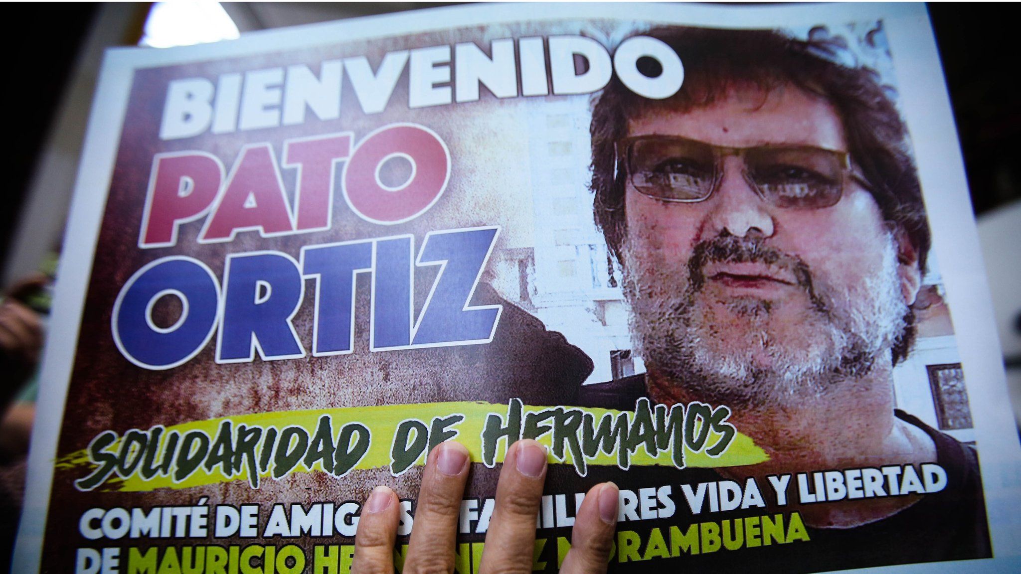 Supporters of Patricio Ortiz Montenegro wave posters upon his arrival to Santiago, Chile, 1 February 2019