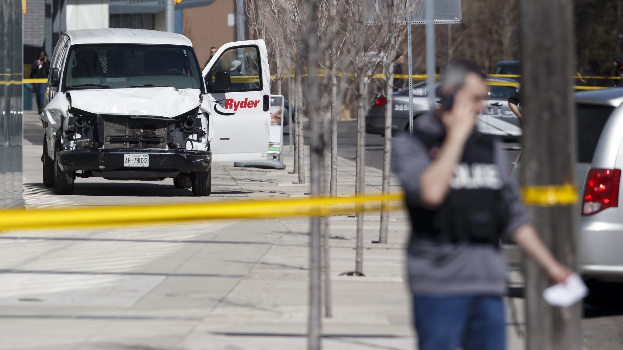Police inspect a van suspected of being involved in fatal collision in Toronto on April 23, 2018