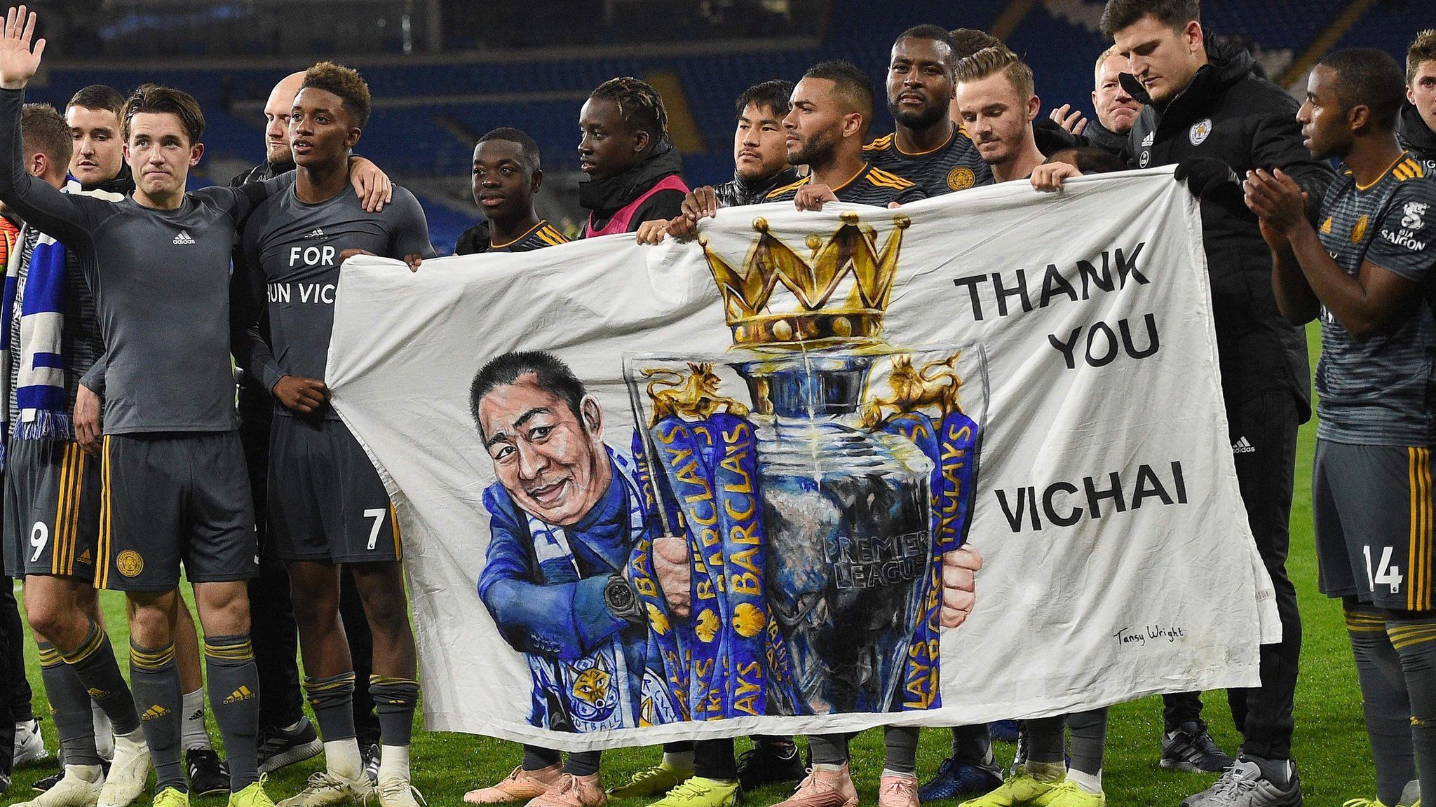 Leicester City players with banner