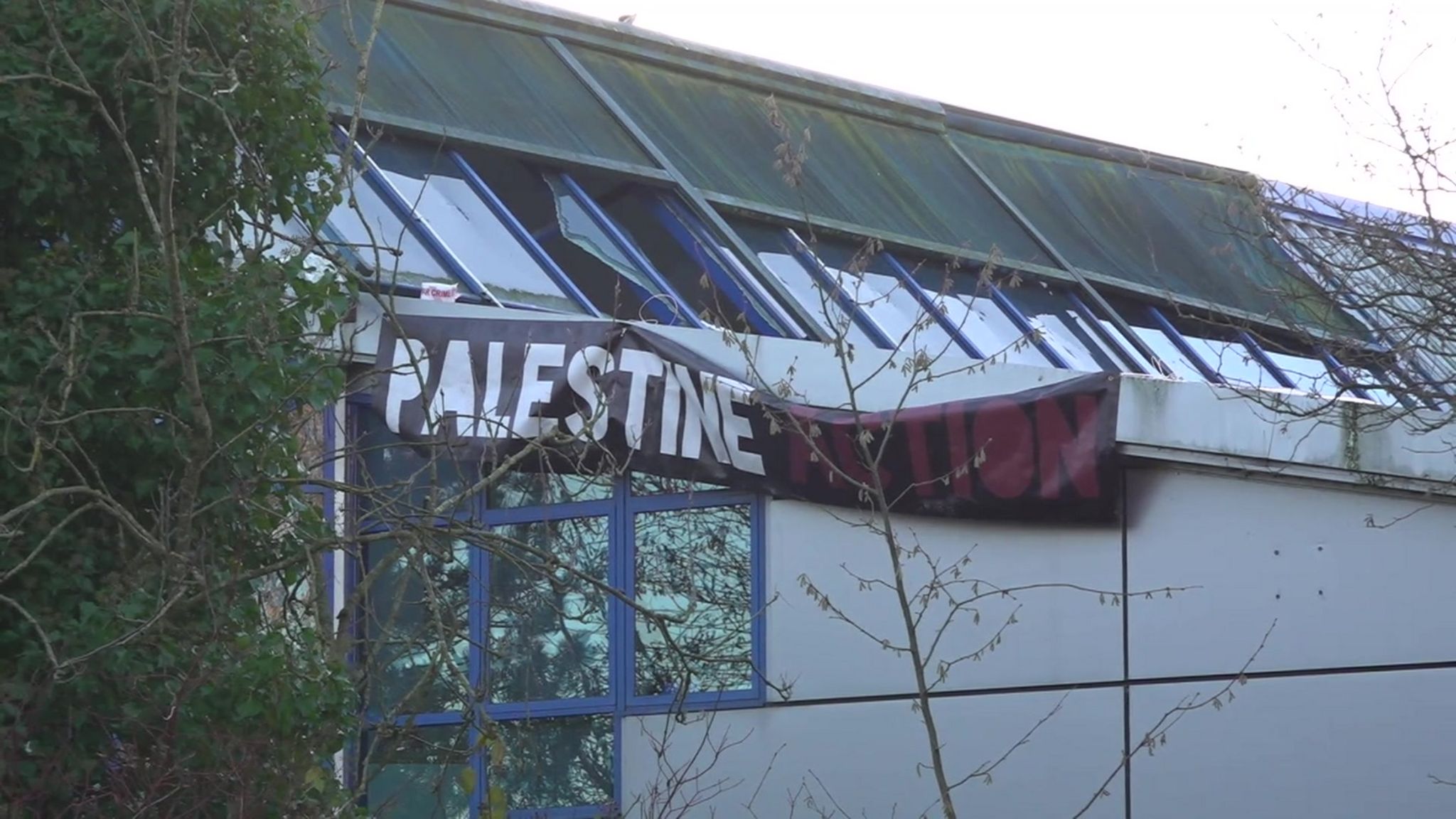 Protesters unfurled a Palestine banner at the factory during the protest