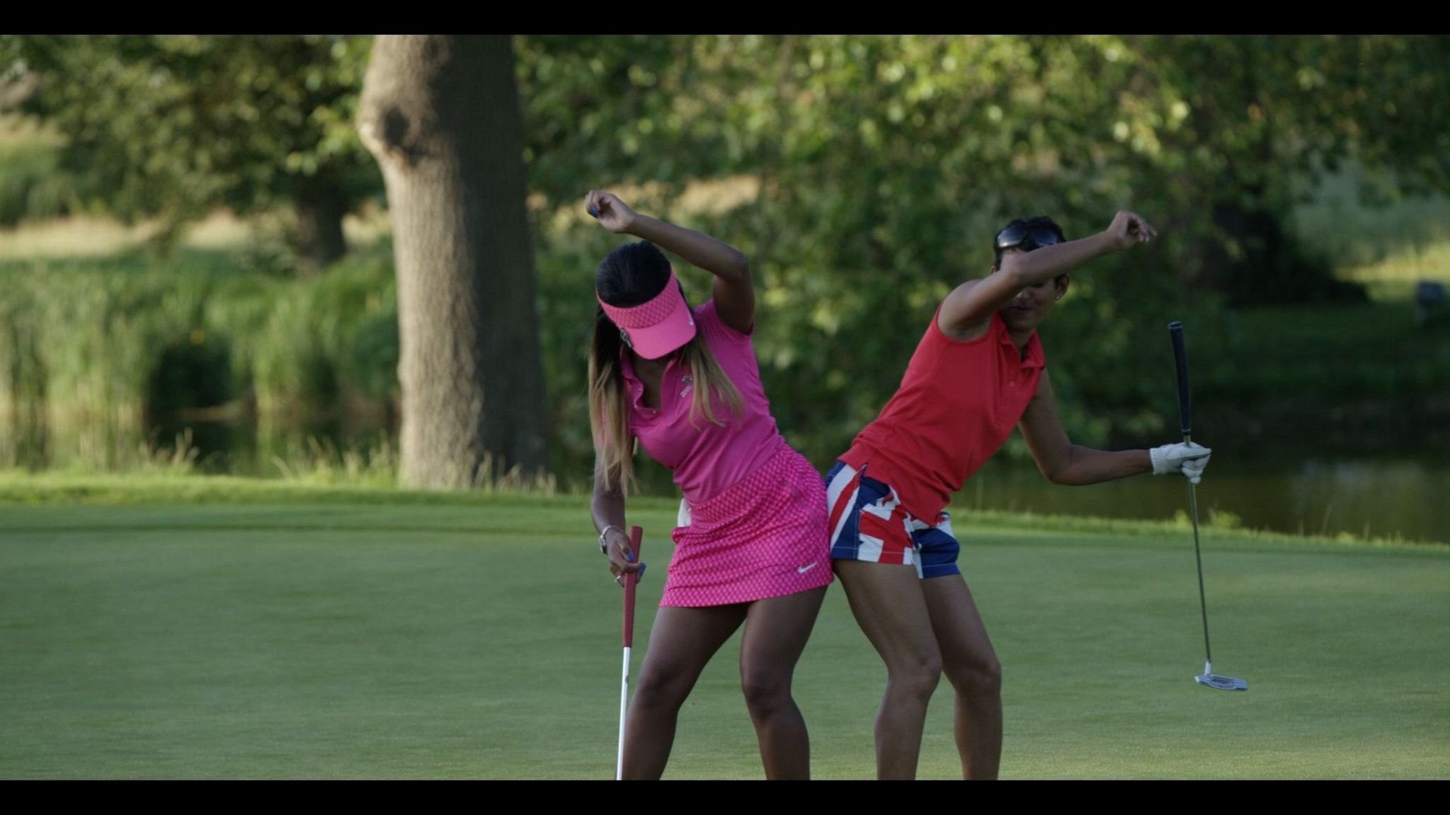 Two women celebrating on a golf course