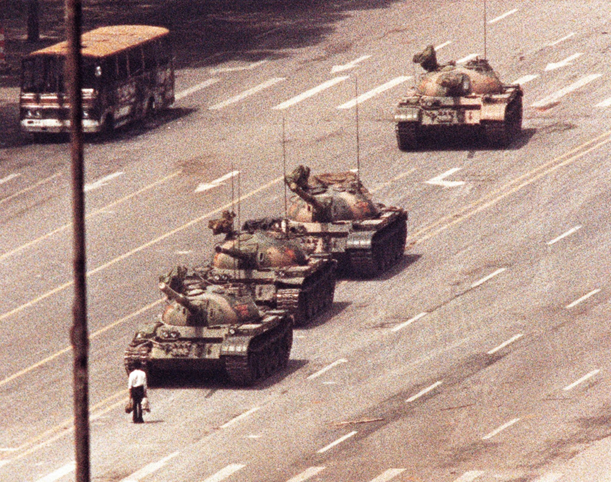 A lone protester confronts a column of Chinese tanks in the Tiananmen Square protests of 1989, Beijin