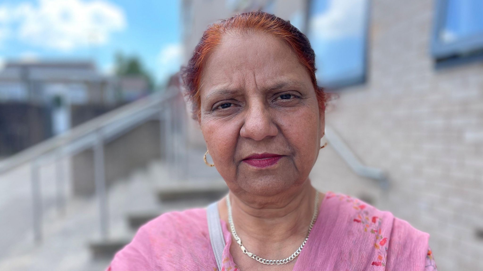 Paramjit Kaur, pictured in Leicester wearing a chain necklace and pink clothing