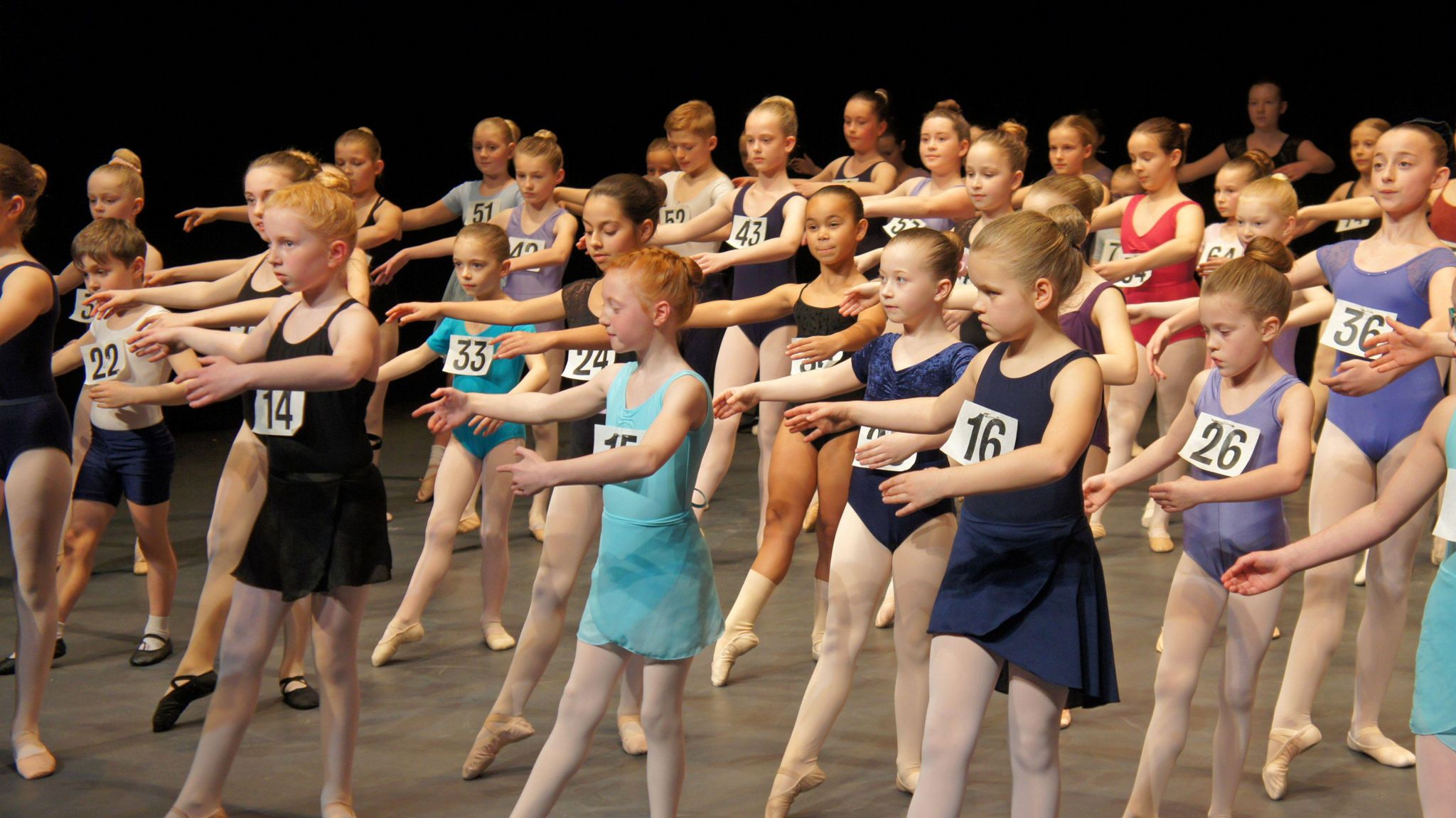Auditionees in a ballet pose