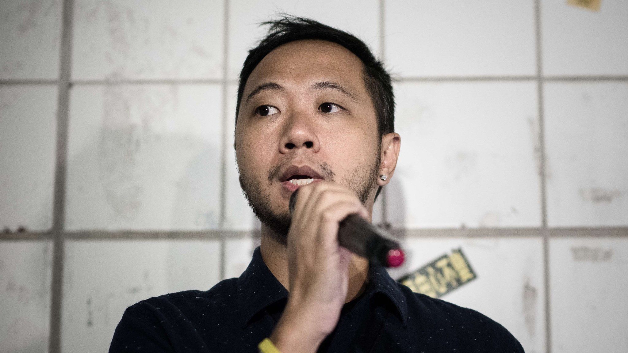 Political activist Ken Tsang talks to the media at the spot where he was allegedly beaten up by policemen in Hong Kong a year ago, on 14 October 2015.