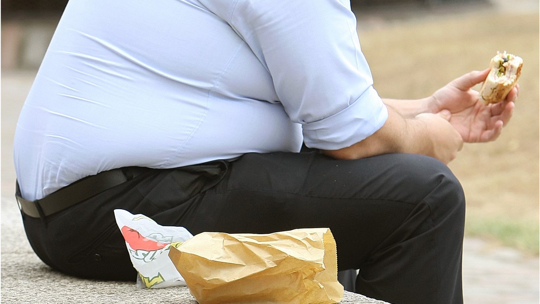 An overweight man eating