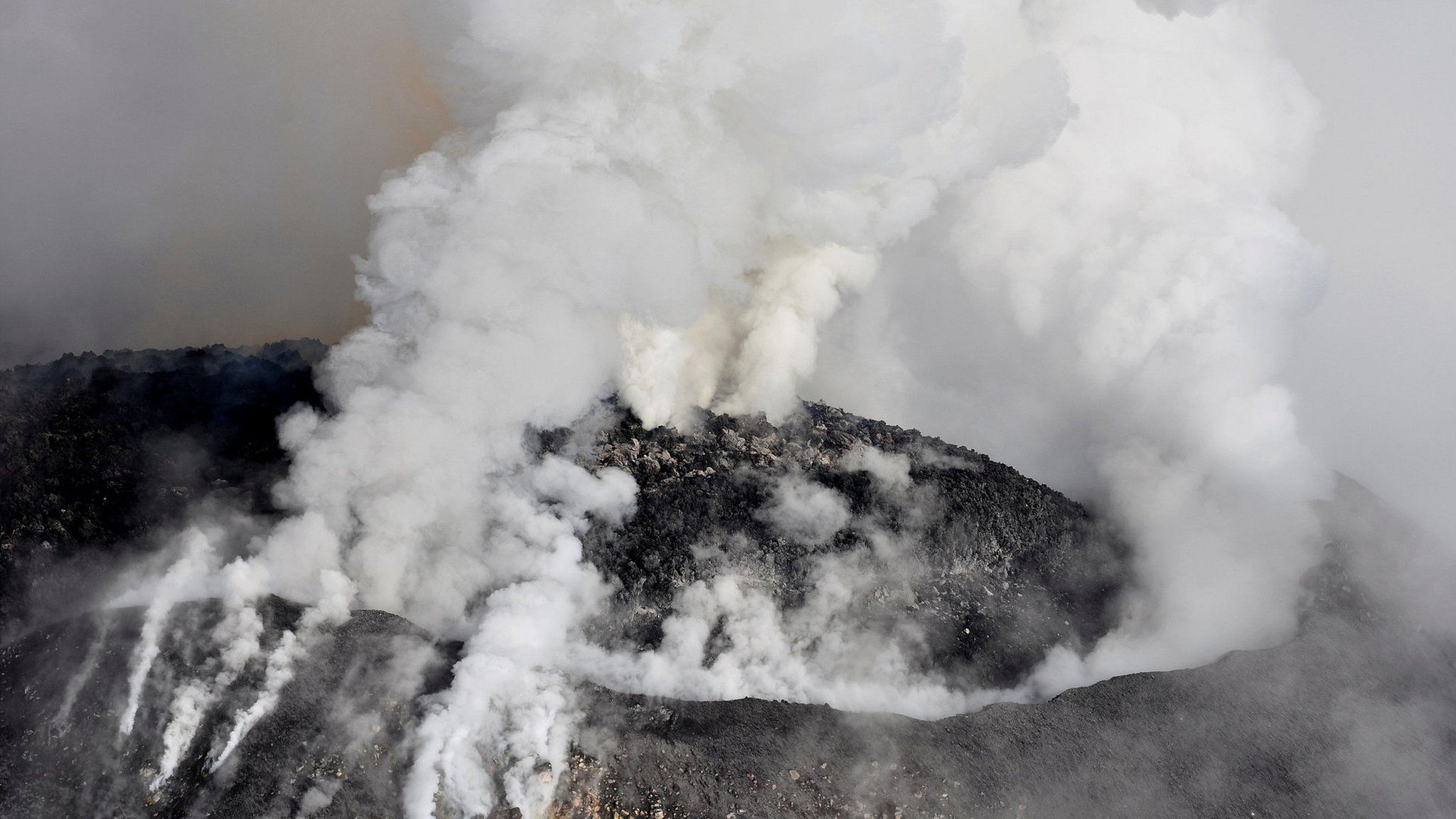 Aerial view of Colima volcano spewing smoke and ash on September 30, 2016
