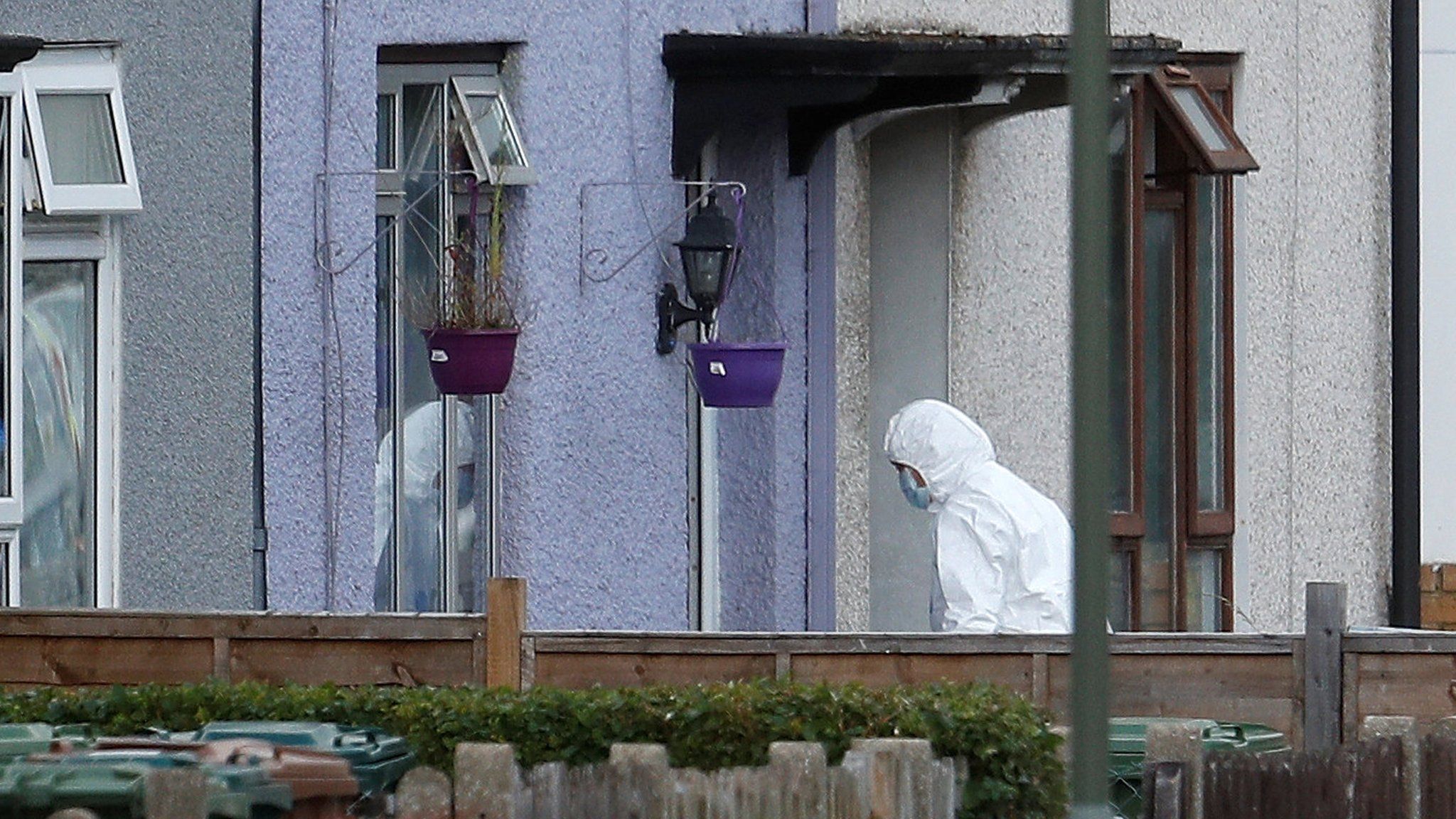 Forensic officer enters a house in Sunbury