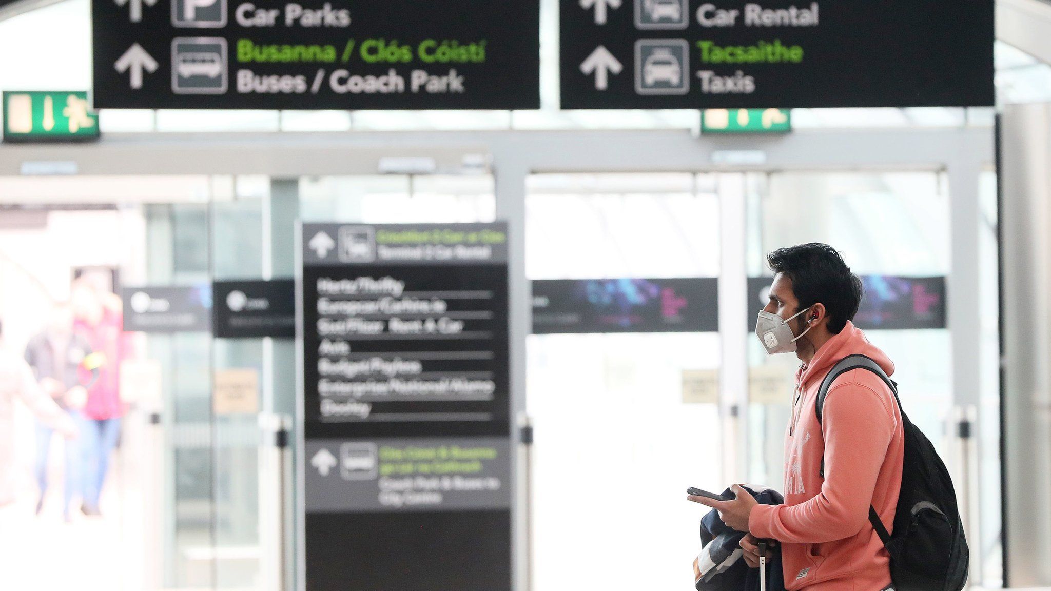 A man wearing a facemask in the arrivals hall at Dublin Airport