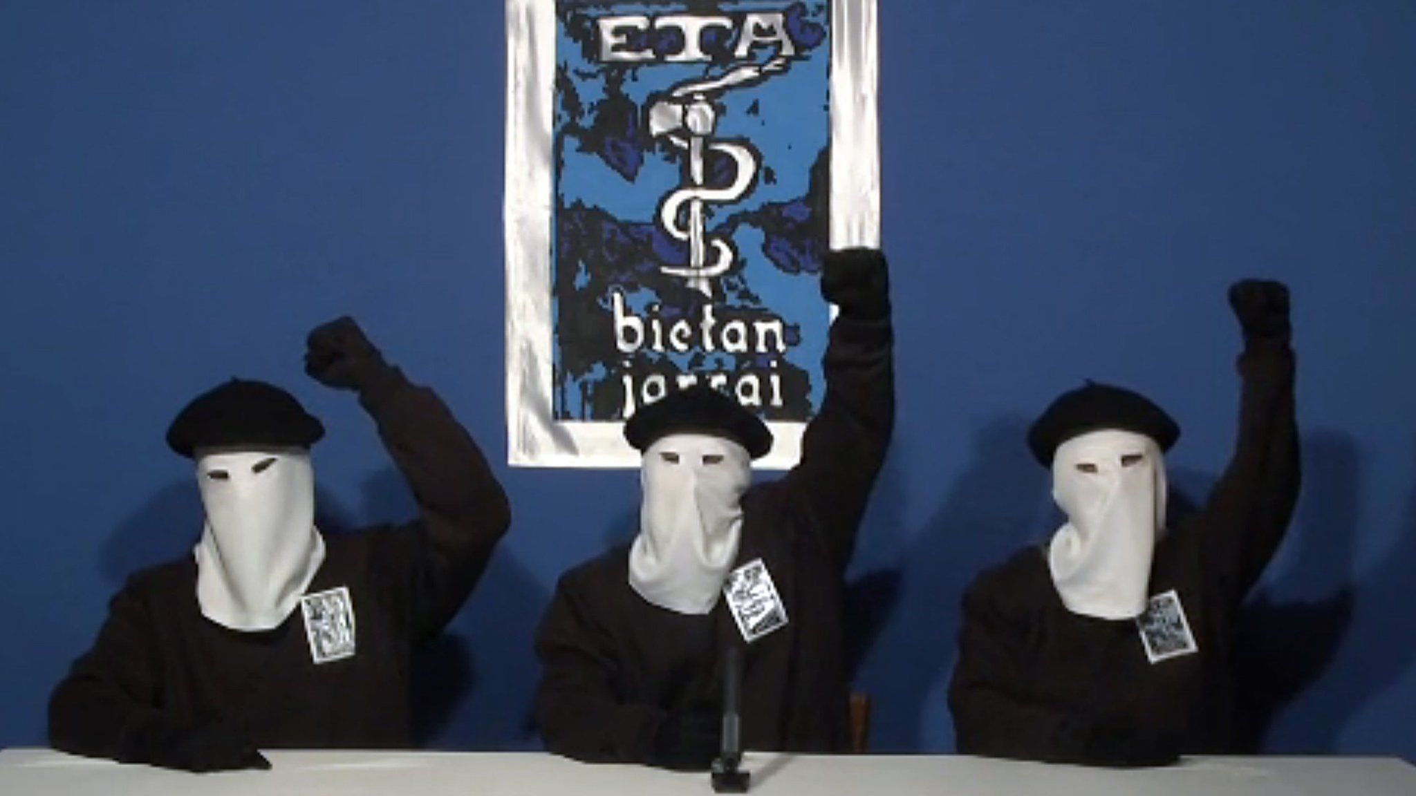 Three ETA militants dressed in black shirts