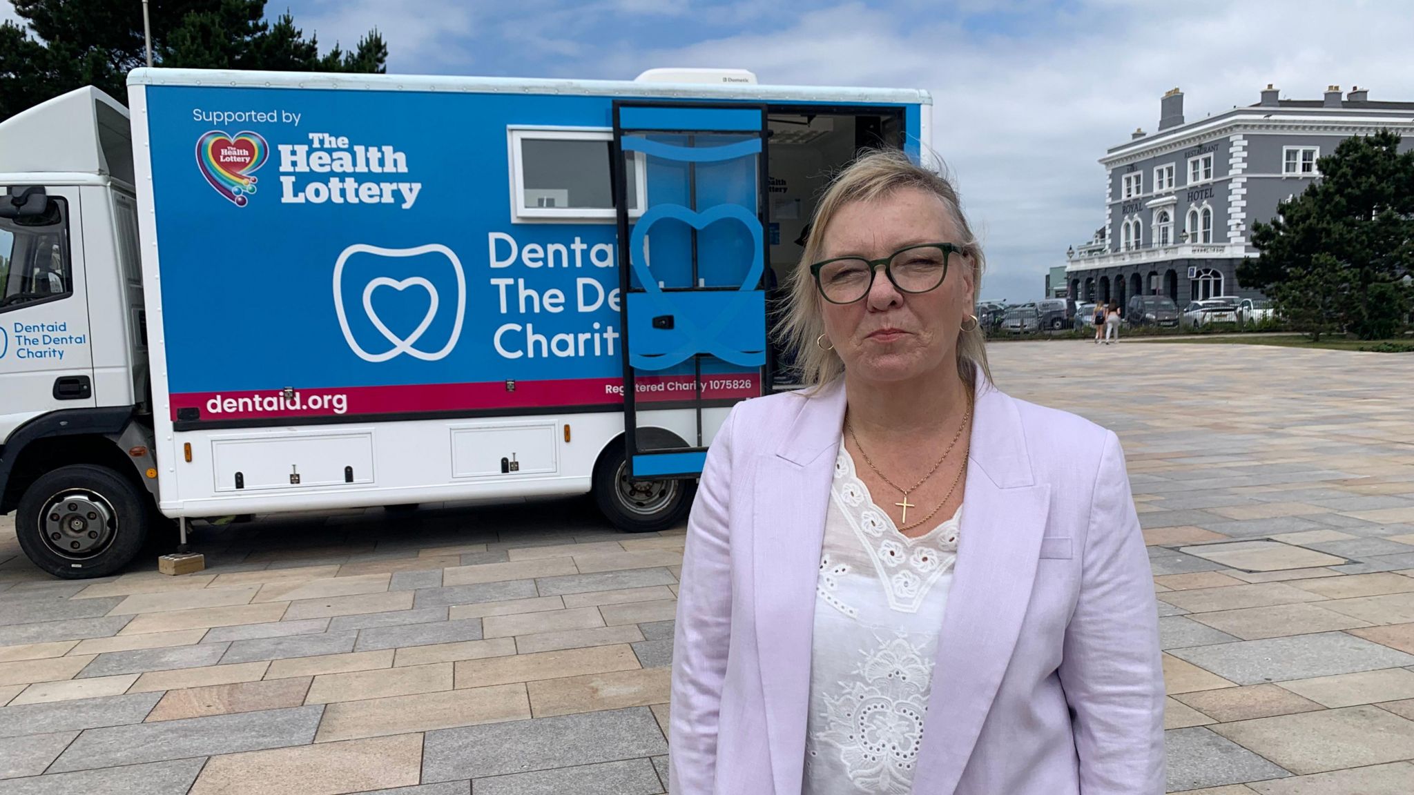 Jill Flanagan standing in front of mobile dentist unit