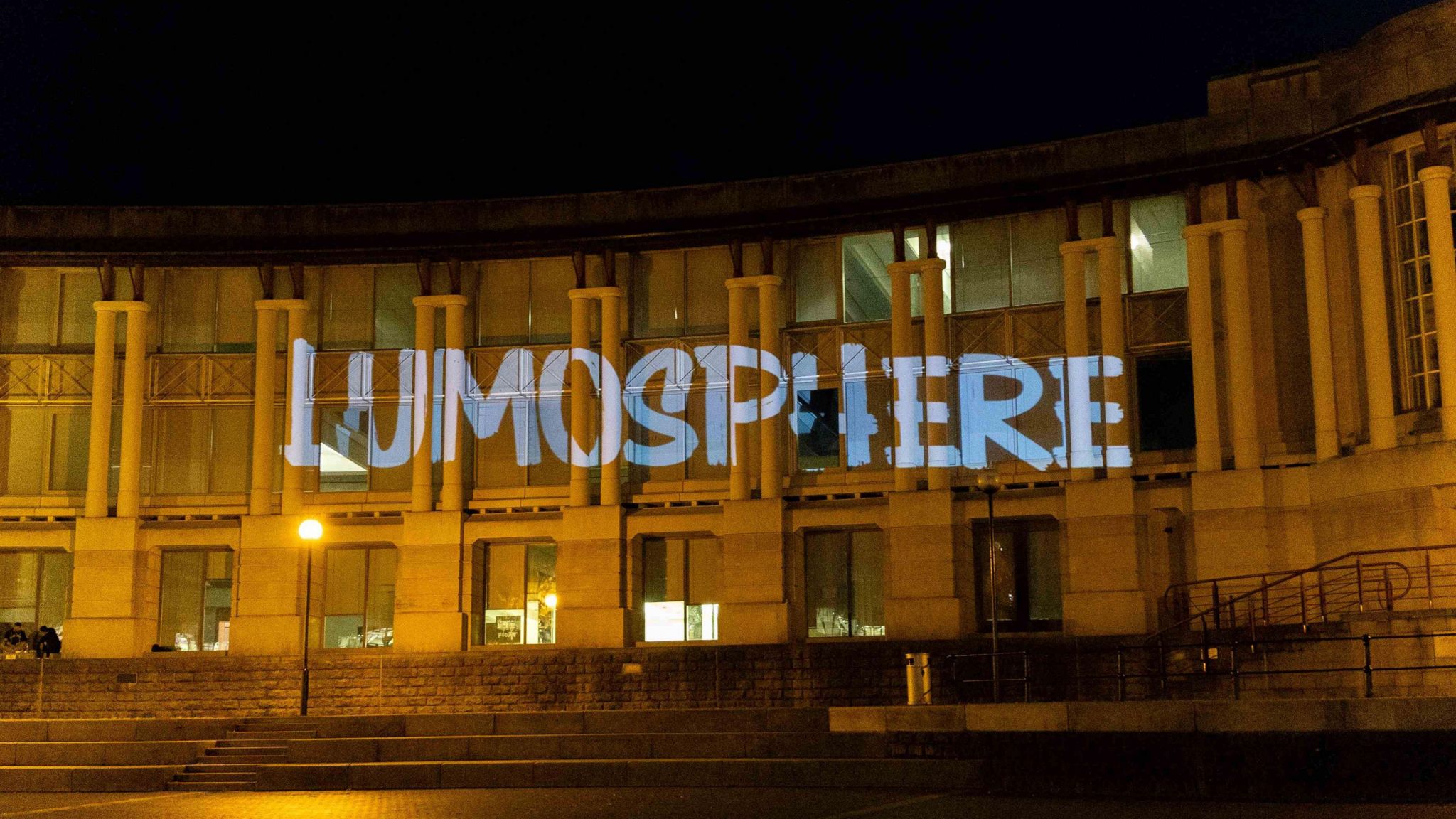 A building with the Lumosphere logo projected onto it. 