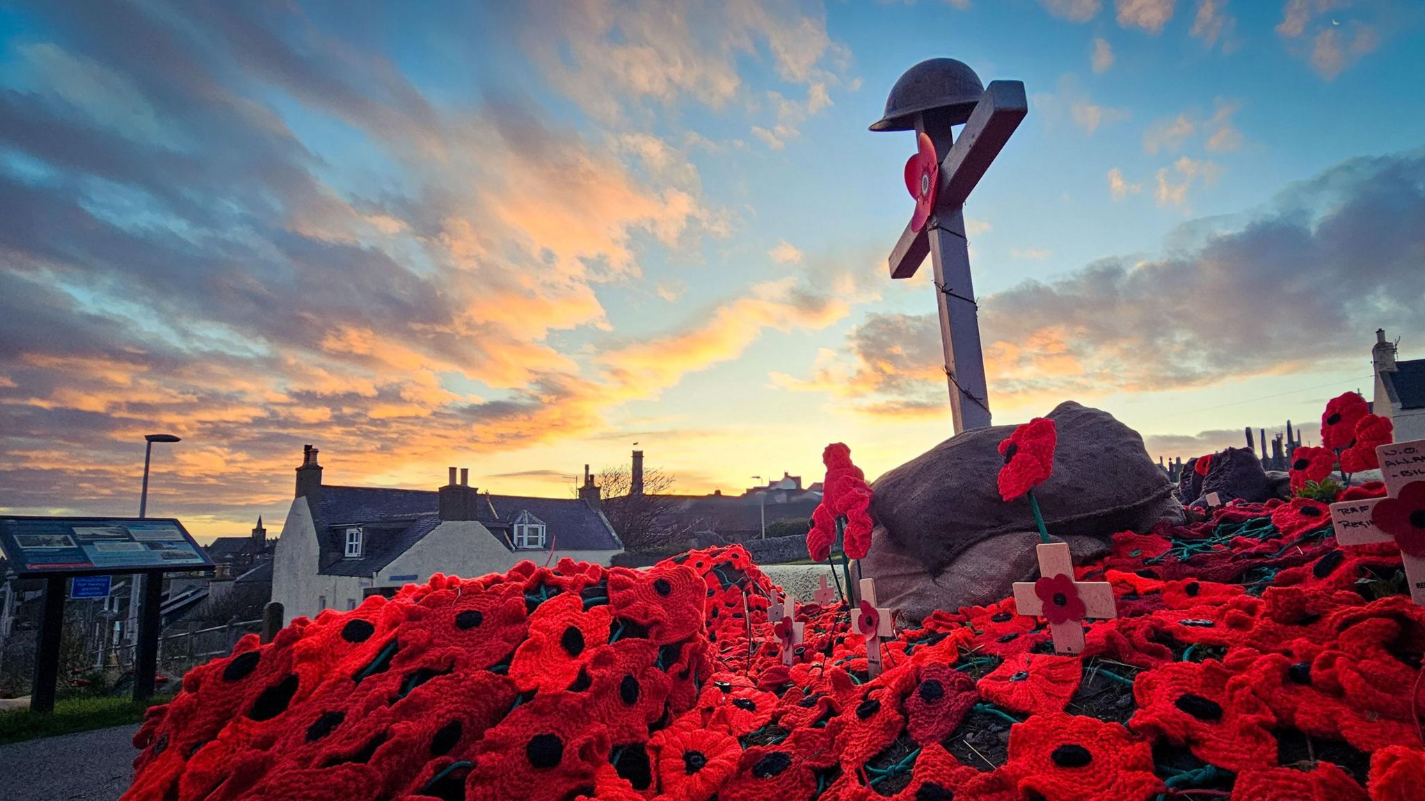 The poppy display during sunset with a photo of the cross