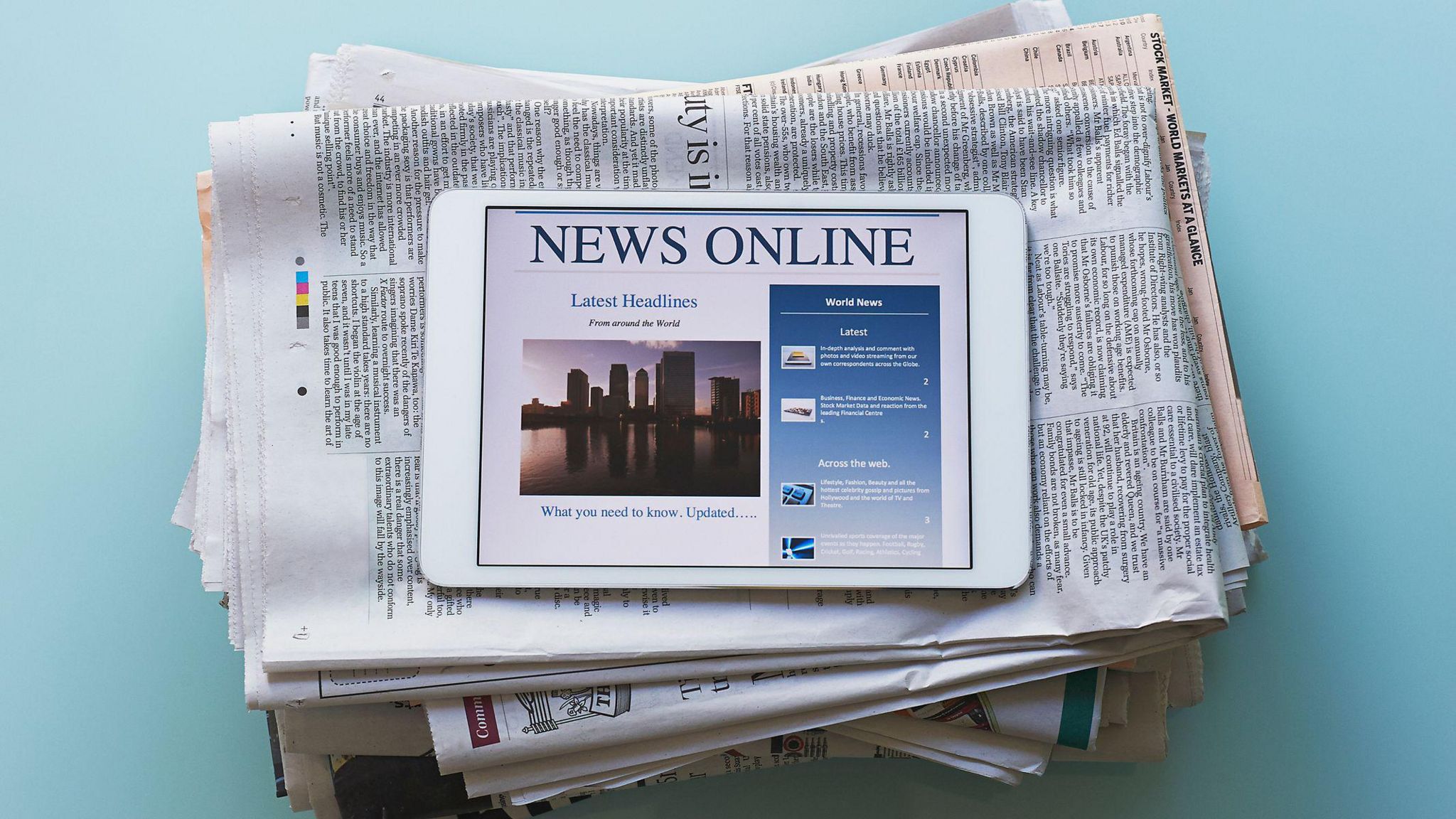 A stack of papers with a tablet on top 