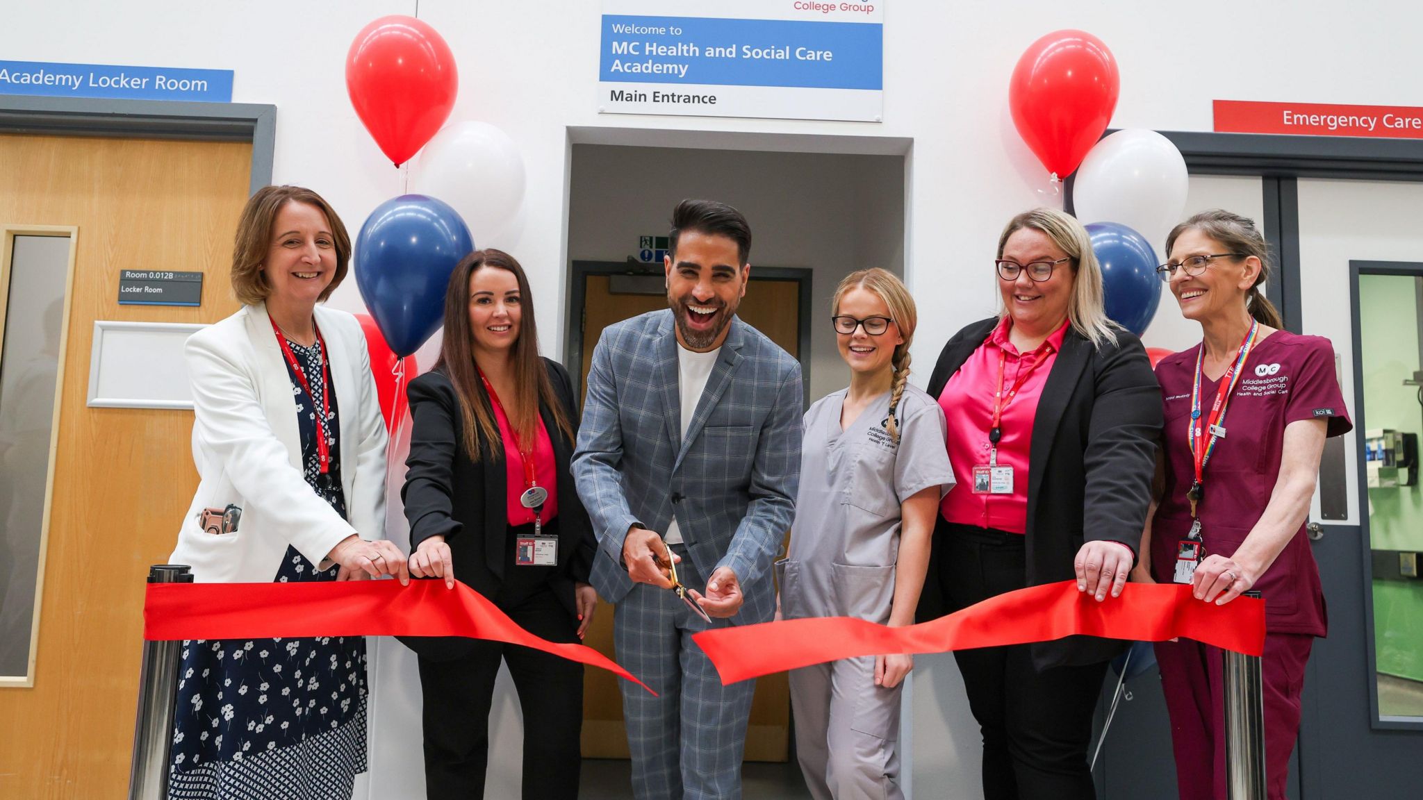 Celebrity TV doctor Ranj Singh cutting the ribbon surrounded by staff and students at Middlesbrough College