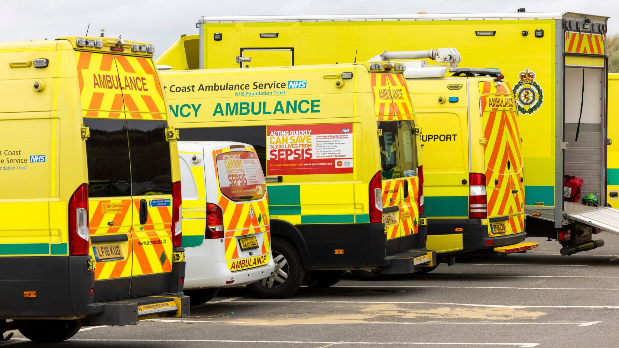 Five South East Coast Ambulance Service vehicles parked next to each other 