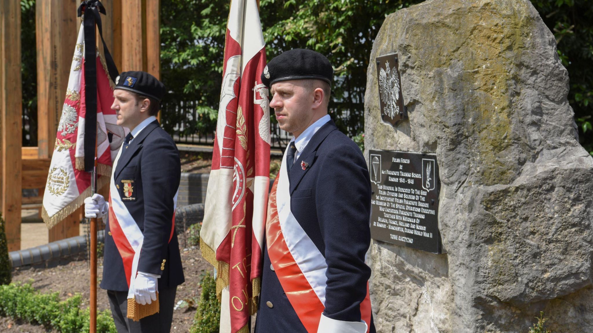 Two members of Polish Armed Forces at memorial to Polish paratroopers at the memorial garden