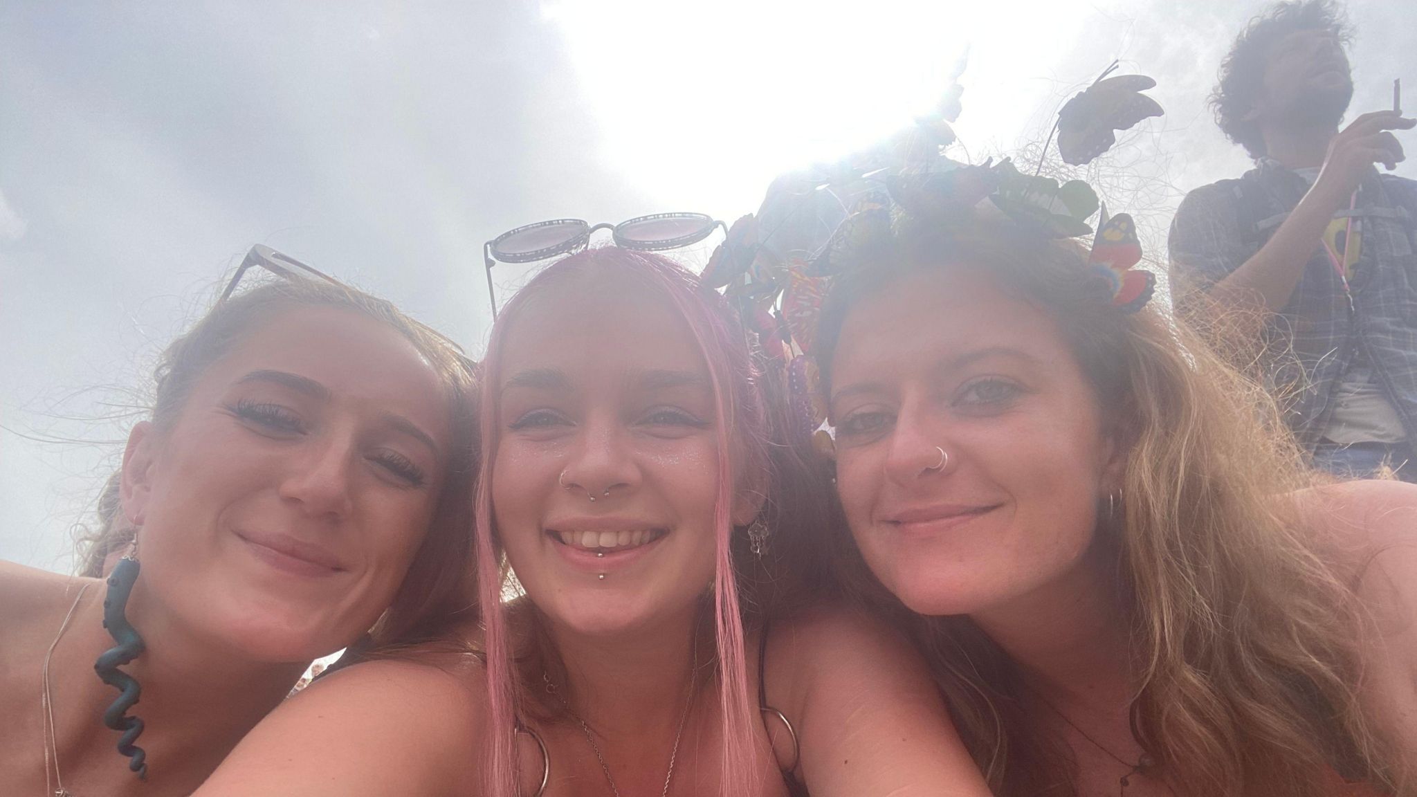 Three women smiling at camera at festival