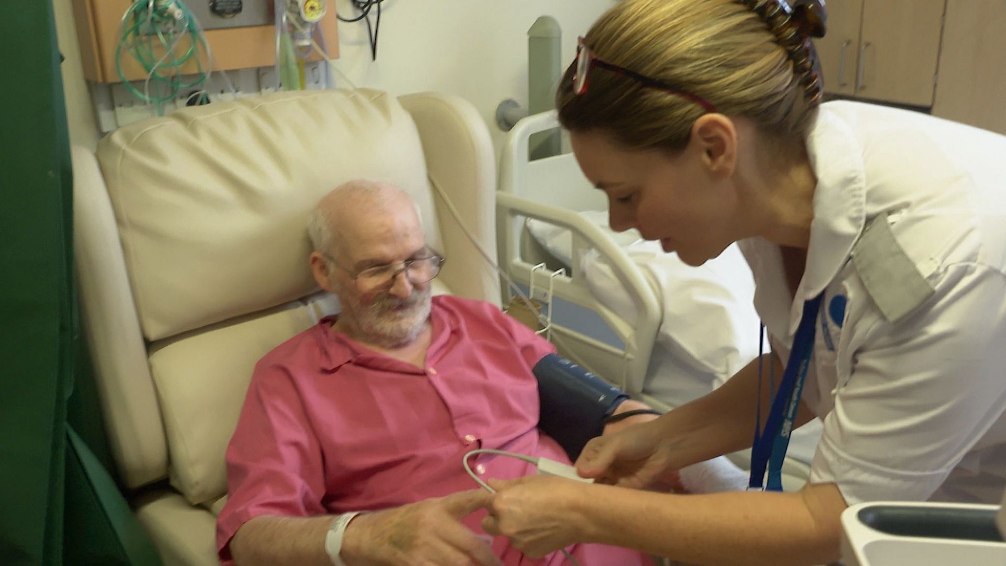 Nurse takes patient's blood pressure