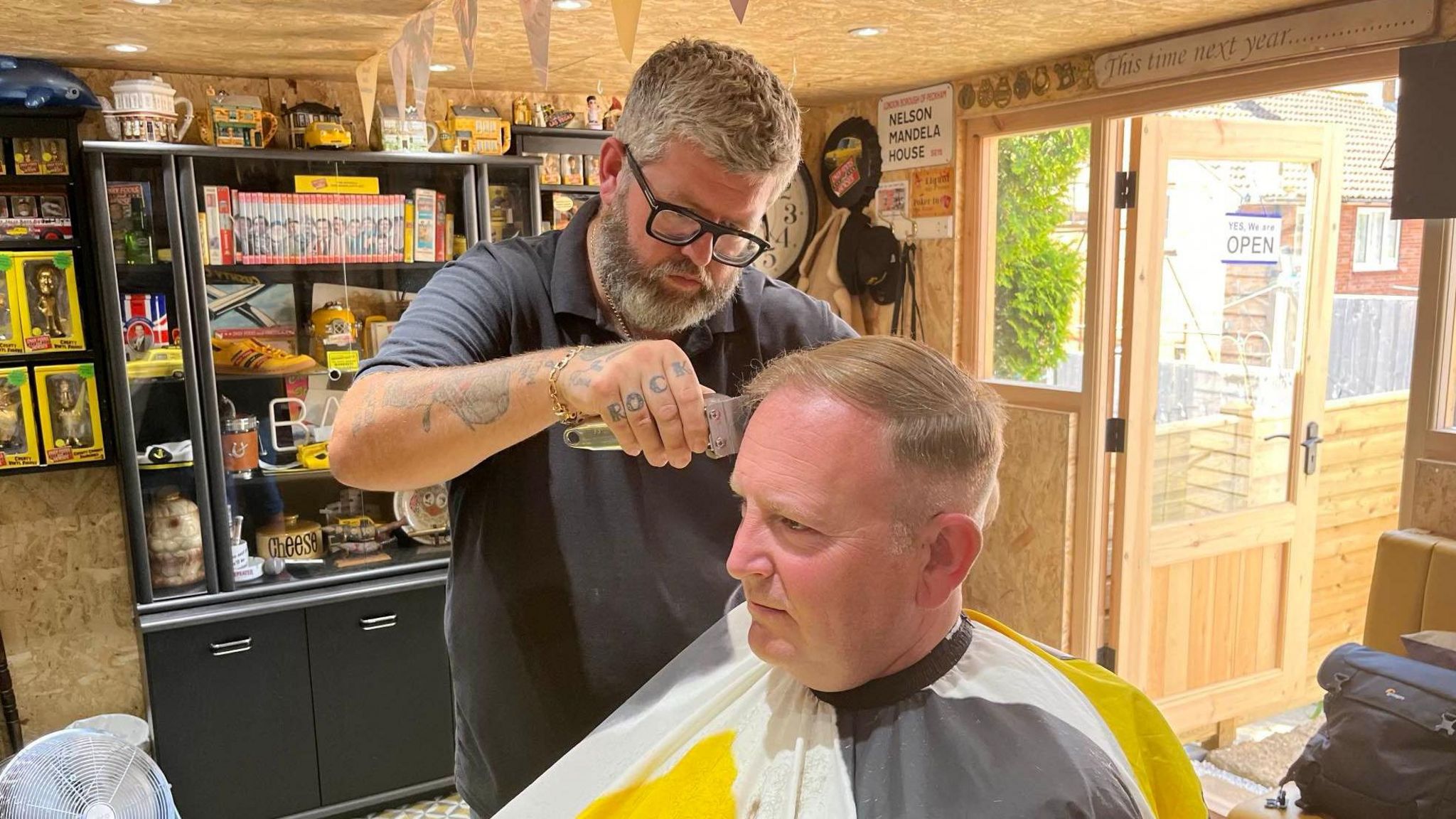 Nathan Scotford cuts Mike Parkinson's hair