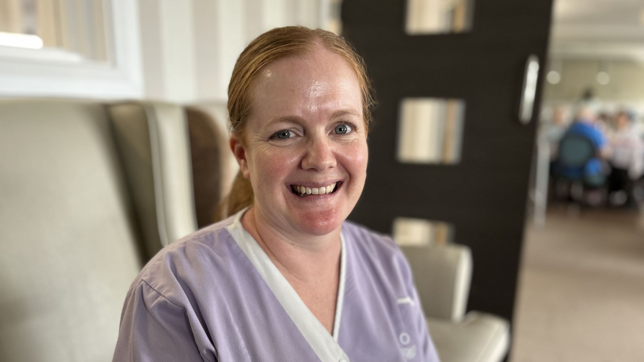 Joanne Seavers from the Lifestyles Team, smiling, wearing a lilac care home tunic