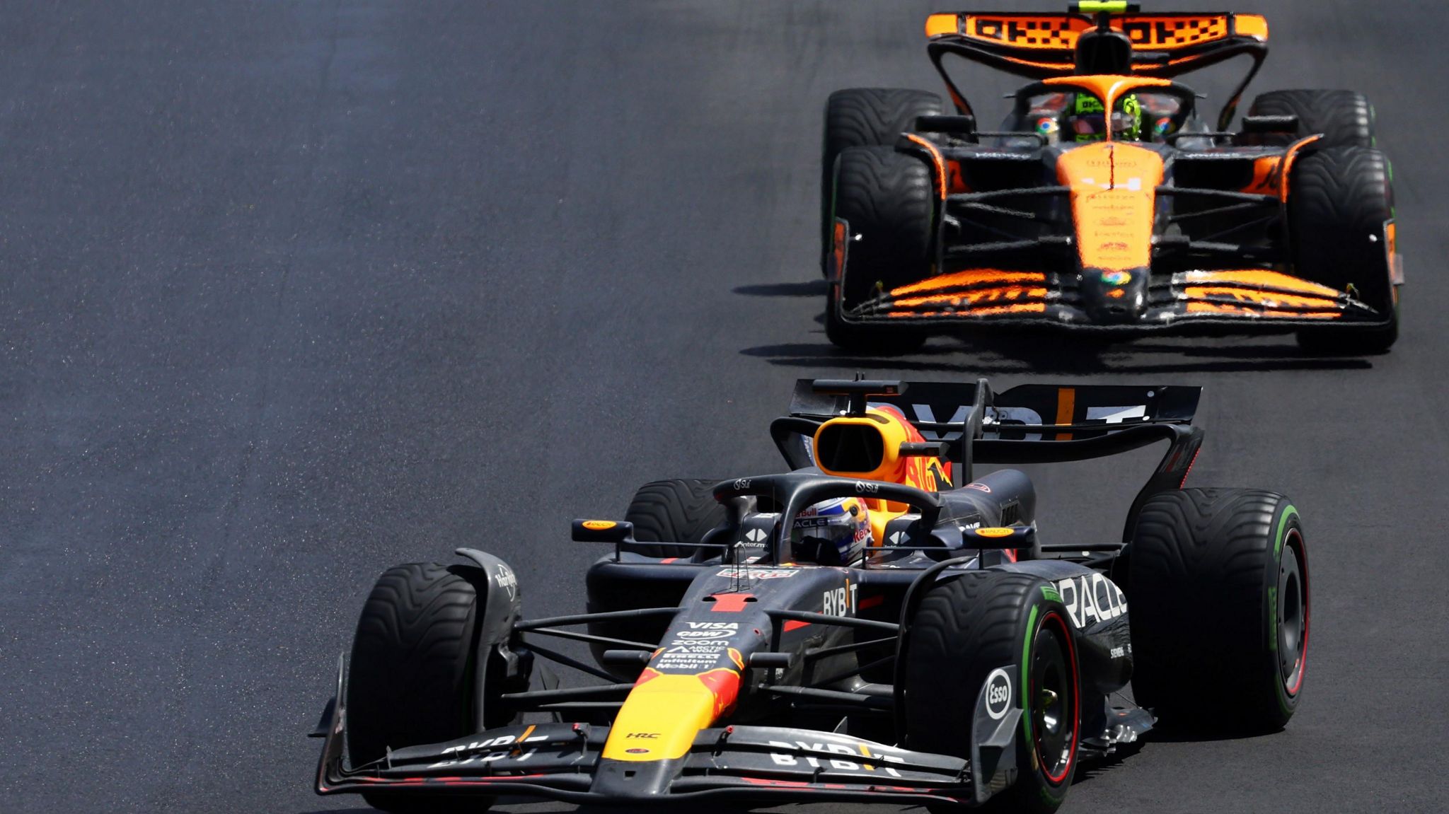 Max Verstappen drives his Red Bull with McLaren's Lando Norris close behind