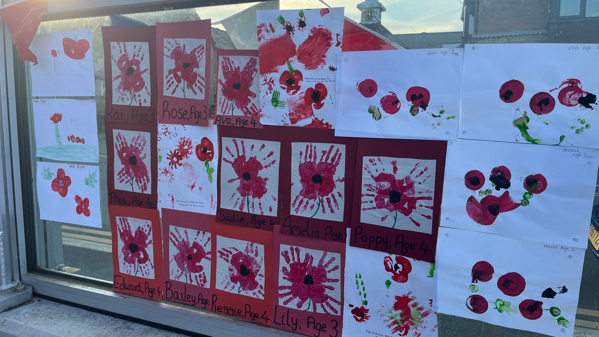A collage of painted poppies by local children