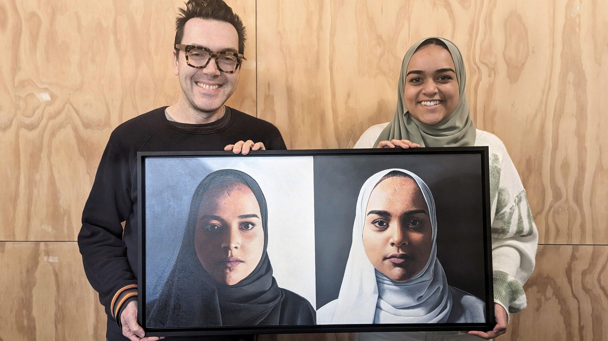 Artist Peter Davis and Fahima Patel holding the two-panel portrait of Fahima