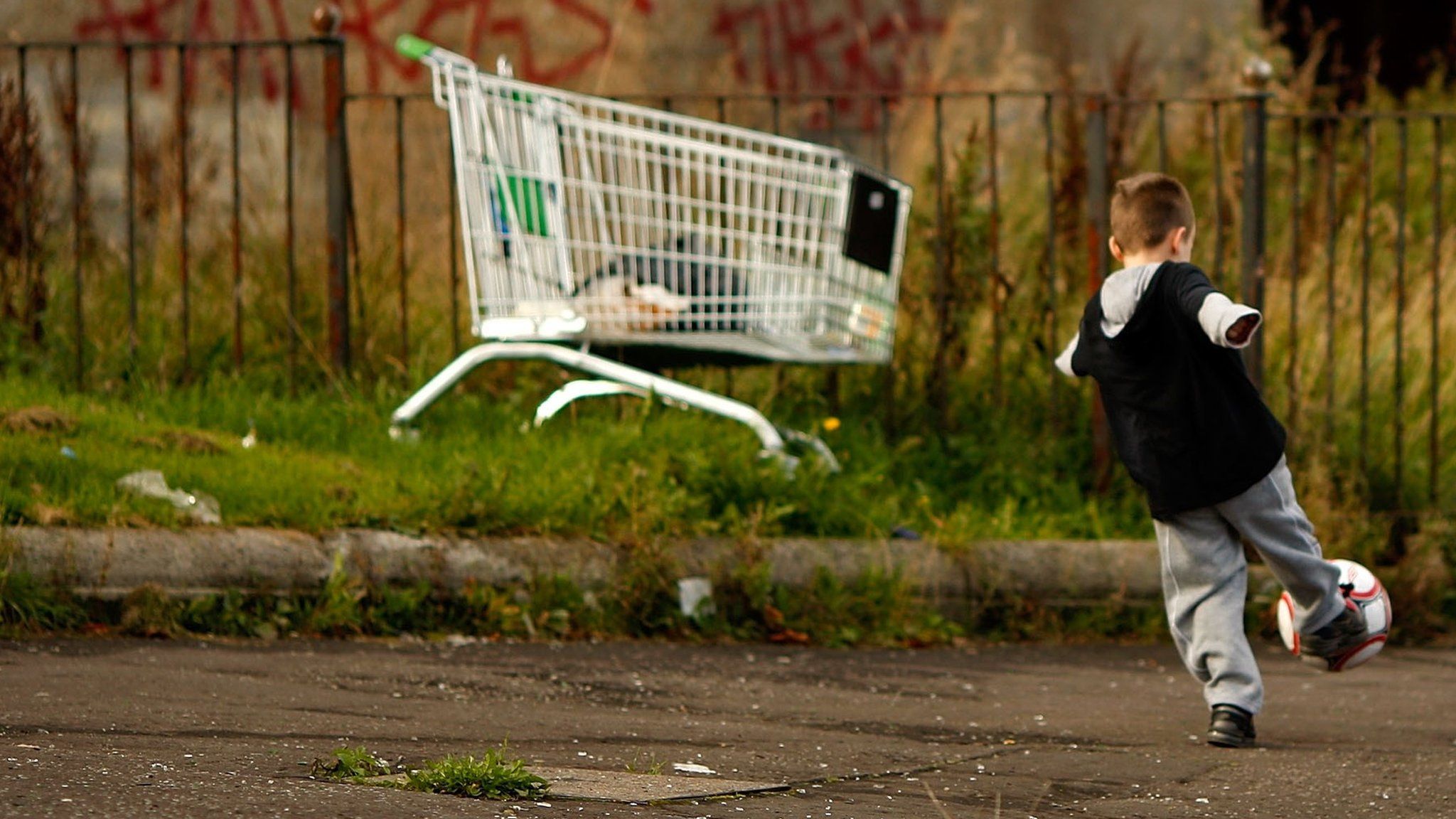 A child playing on a street in Glasgow