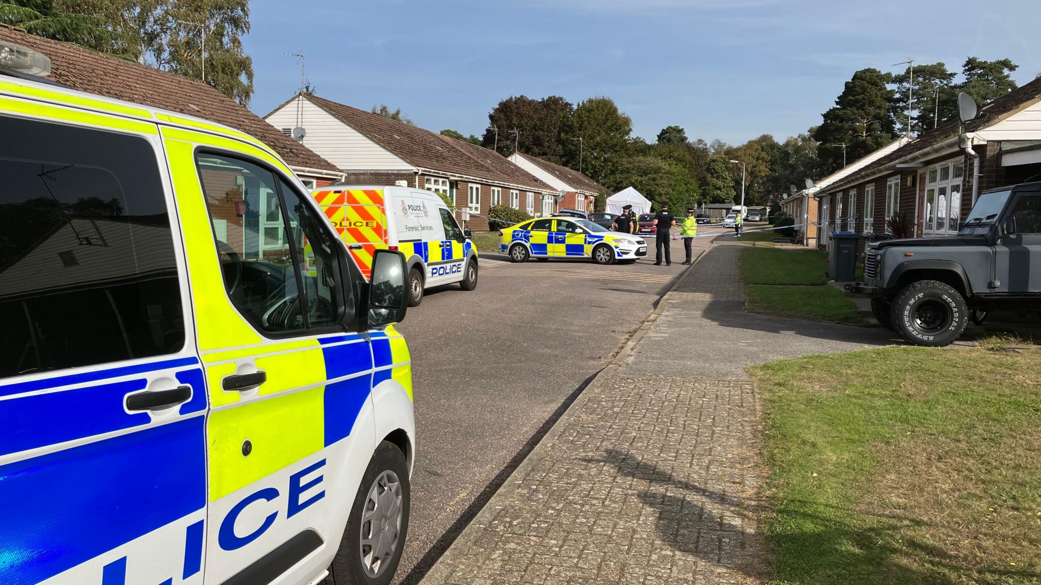 Forensics and police at the scene of an alleged murder in Sutton Heath, Suffolk