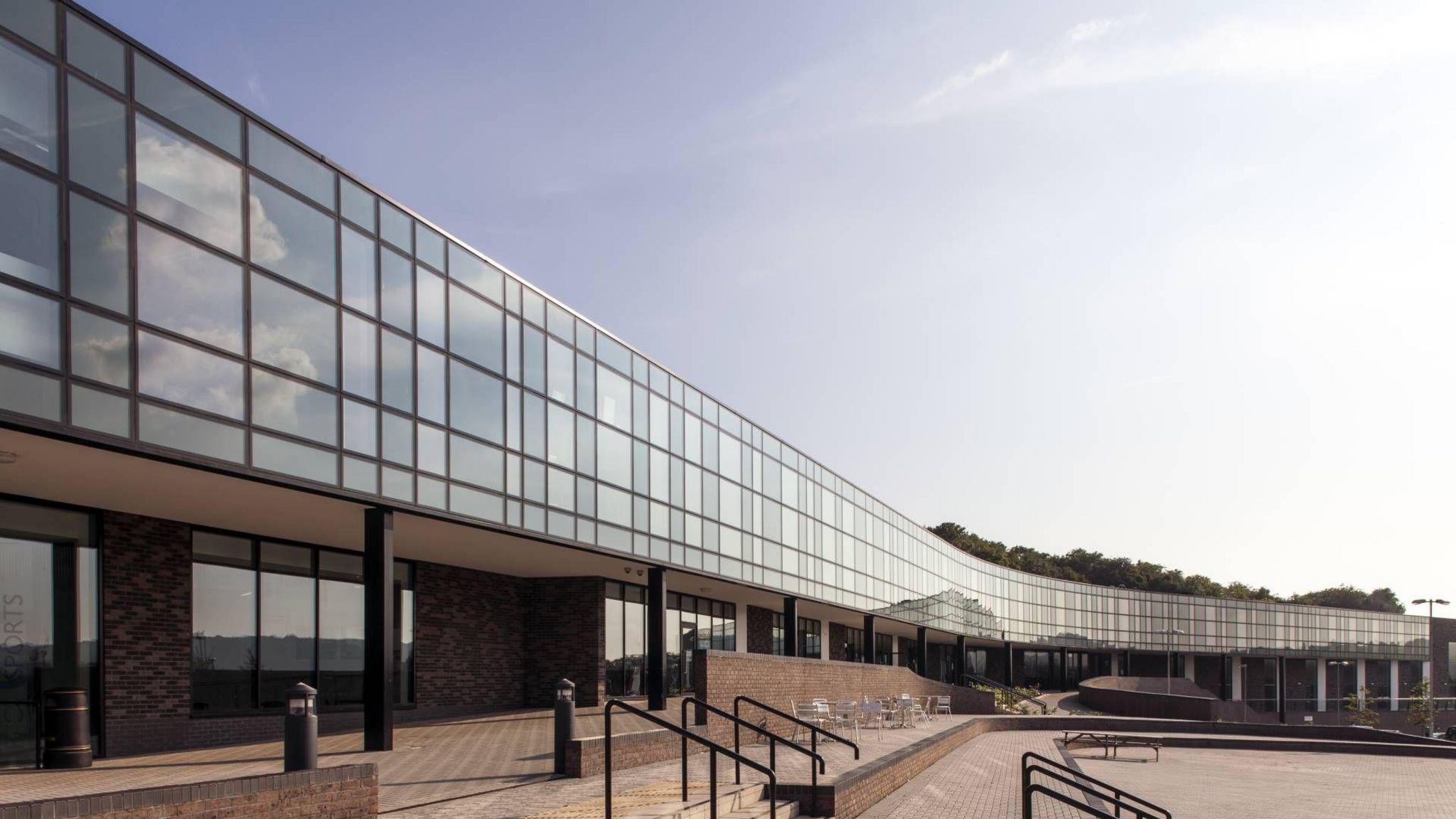 Brighton Aldridge Community Academy school building - a long, thin, glass build