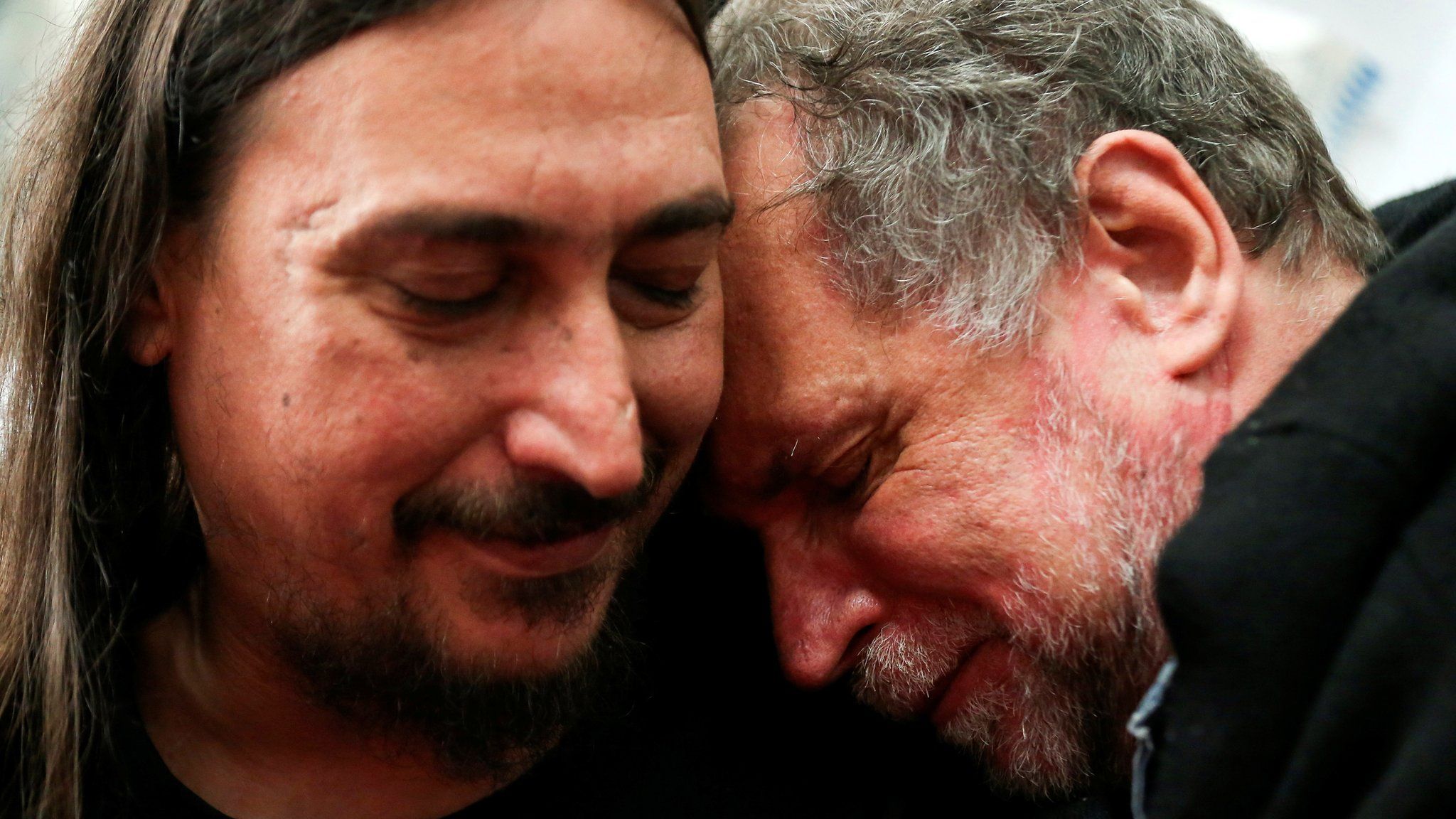 Javier Darroux Mijalchuk, left, embraces his uncle Roberto