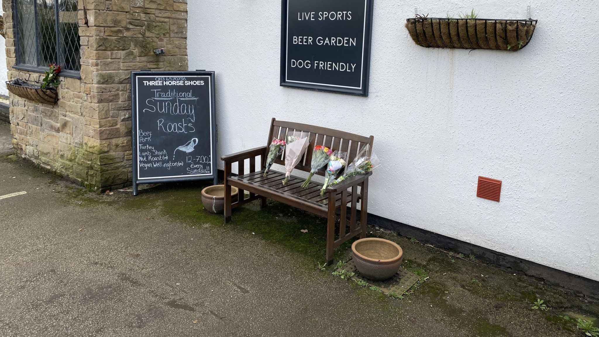 Flowers left outside the Three Horse Shoes pub in Oulton