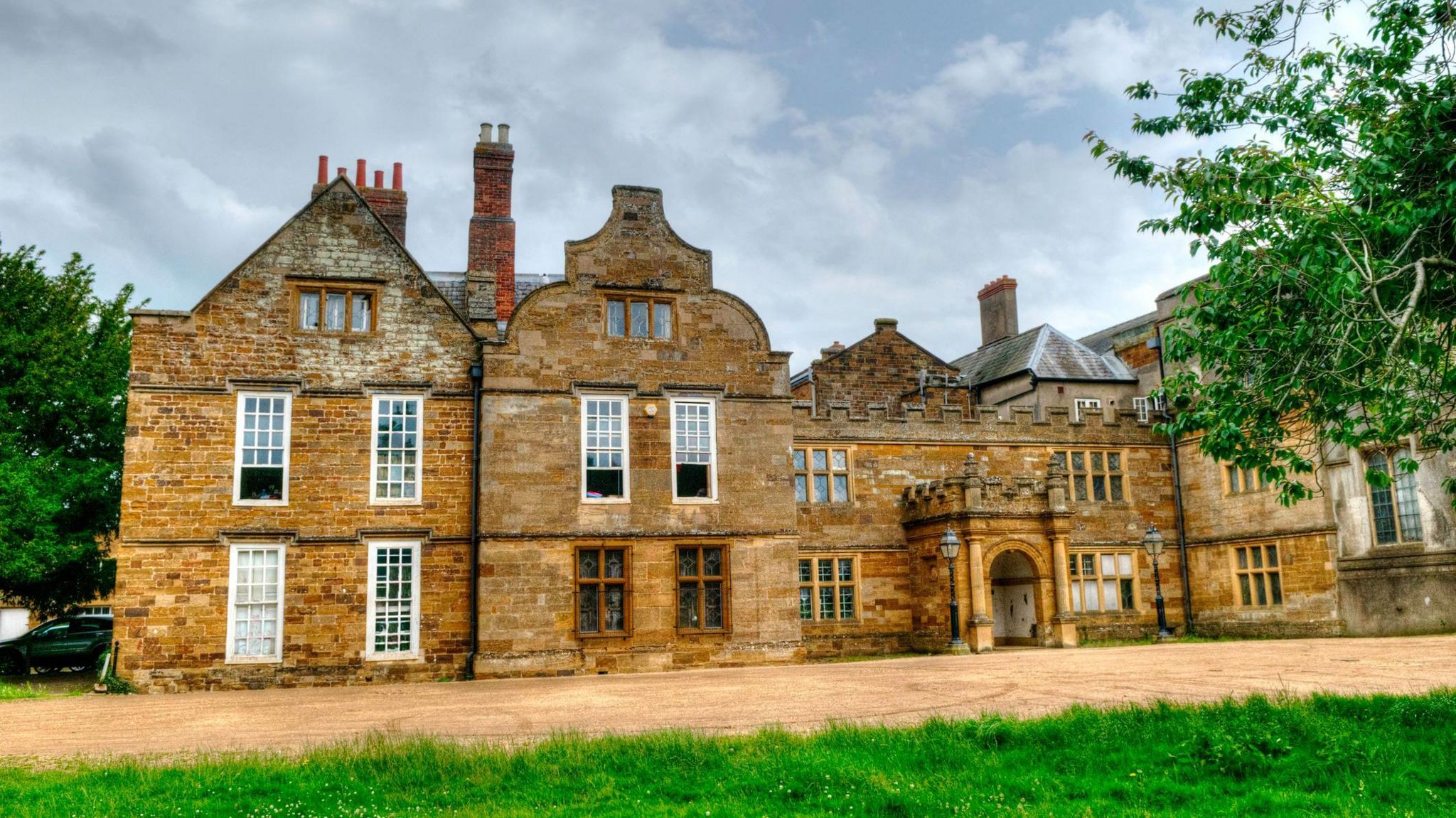 A grand looking building with arches and bay windows