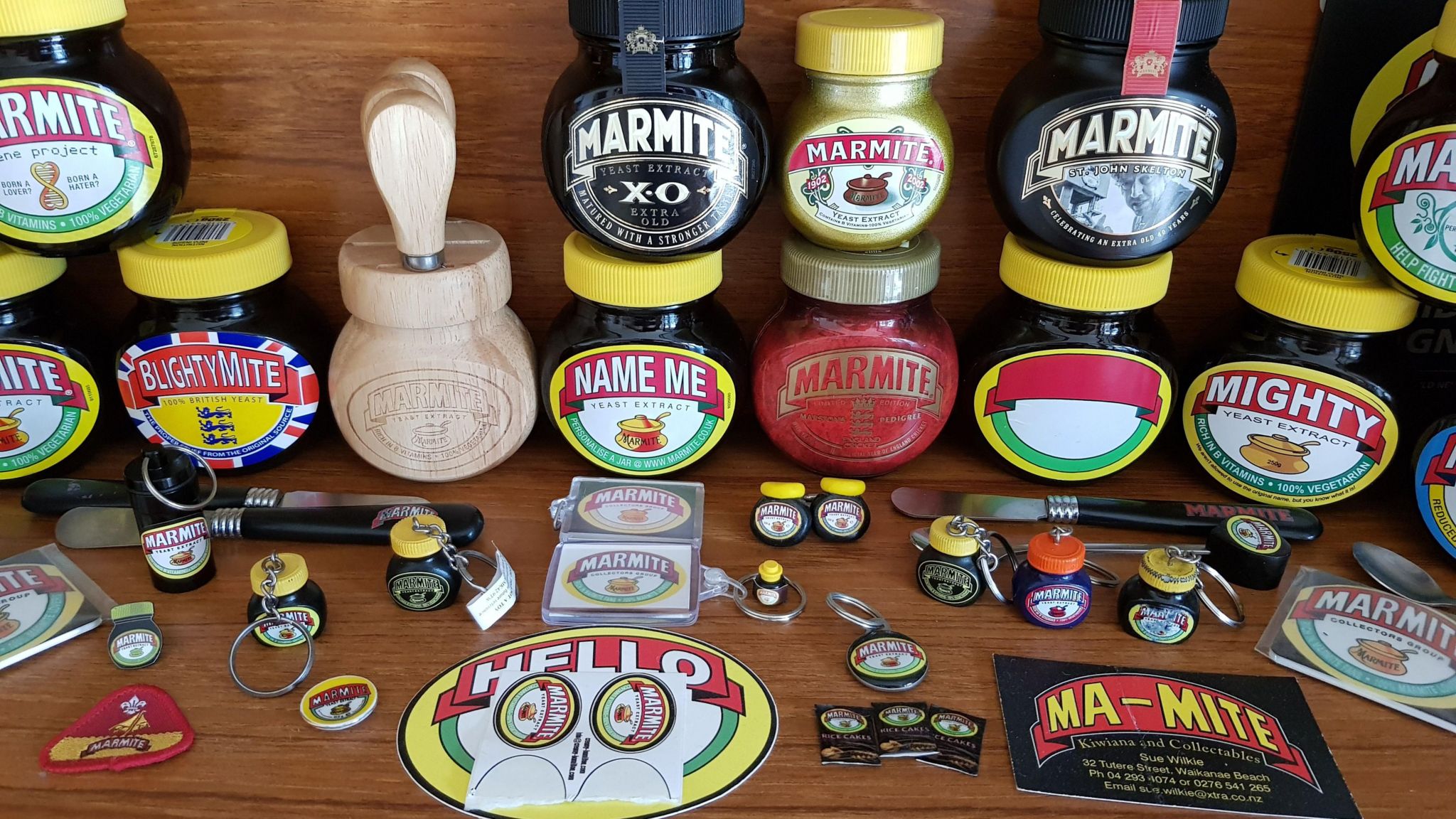 Jars of marmite and marmite related memorabilia on a wooden work surface