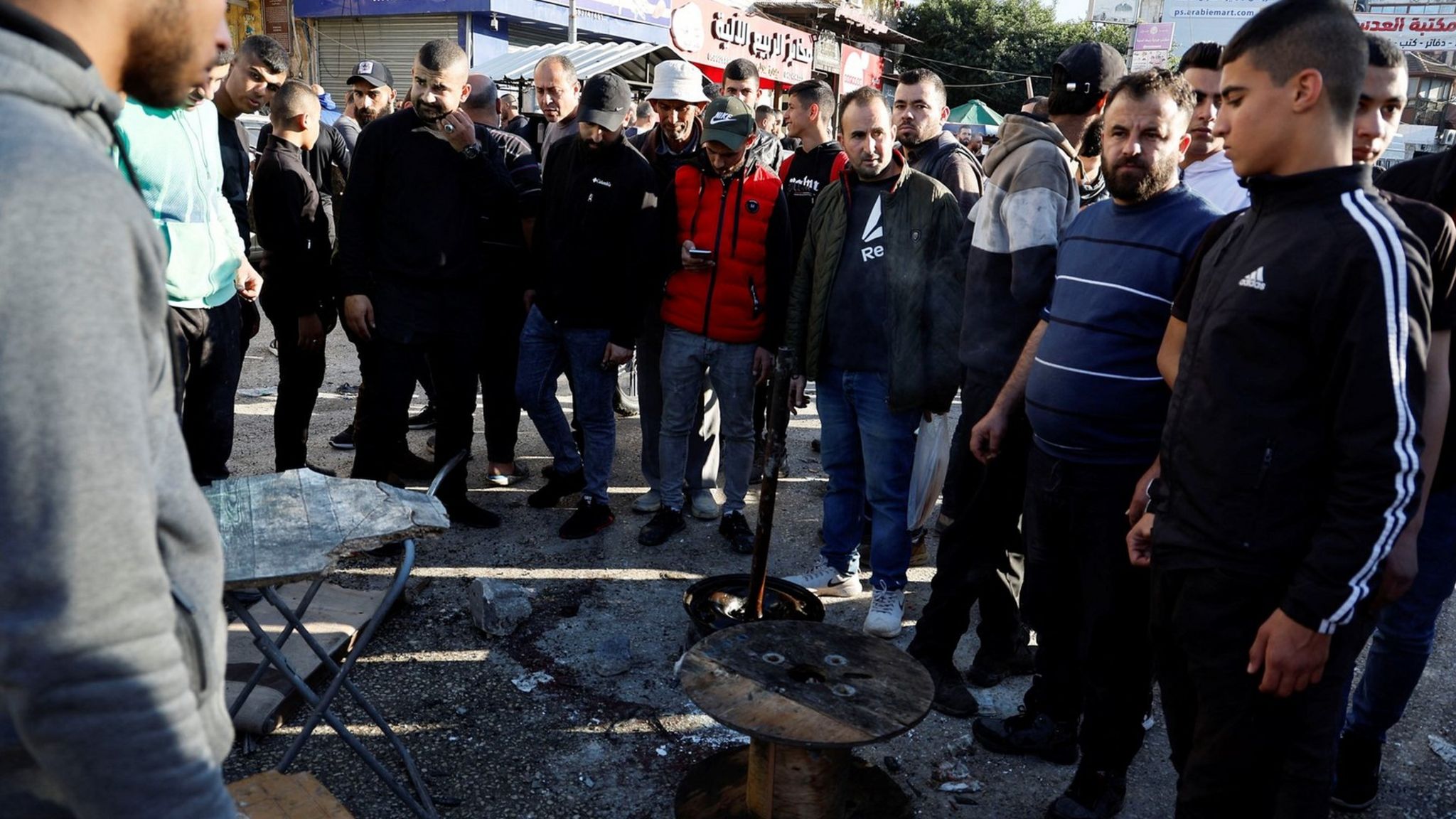 People gather at the site where Omar Awadin, a 16-year-old Palestinian boy, was killed during an Israeli raid in Jenin in the occupied West Bank, (16 March 2023)
