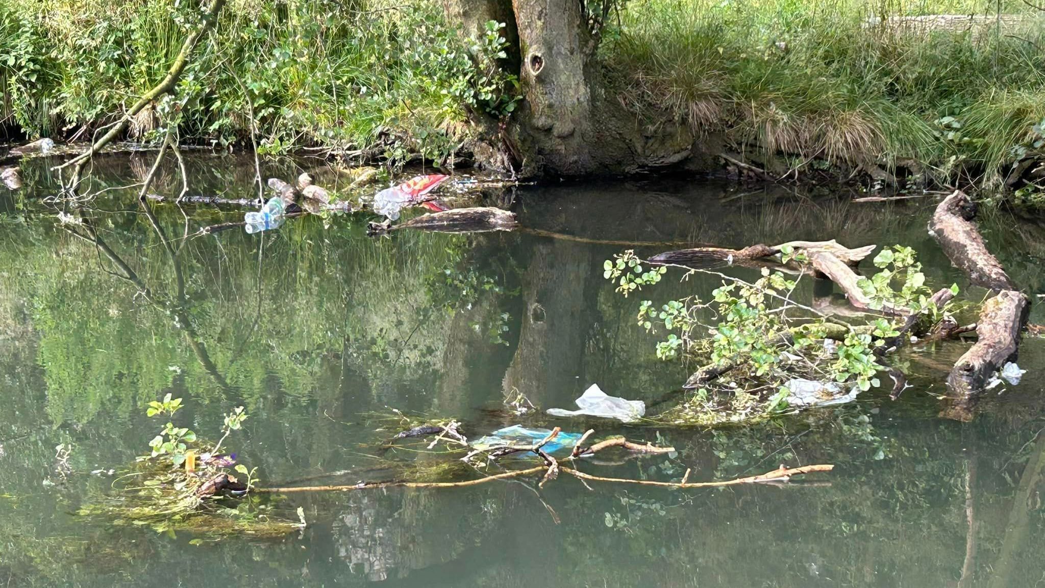 Plastic bottles and other rubbish floating in the river