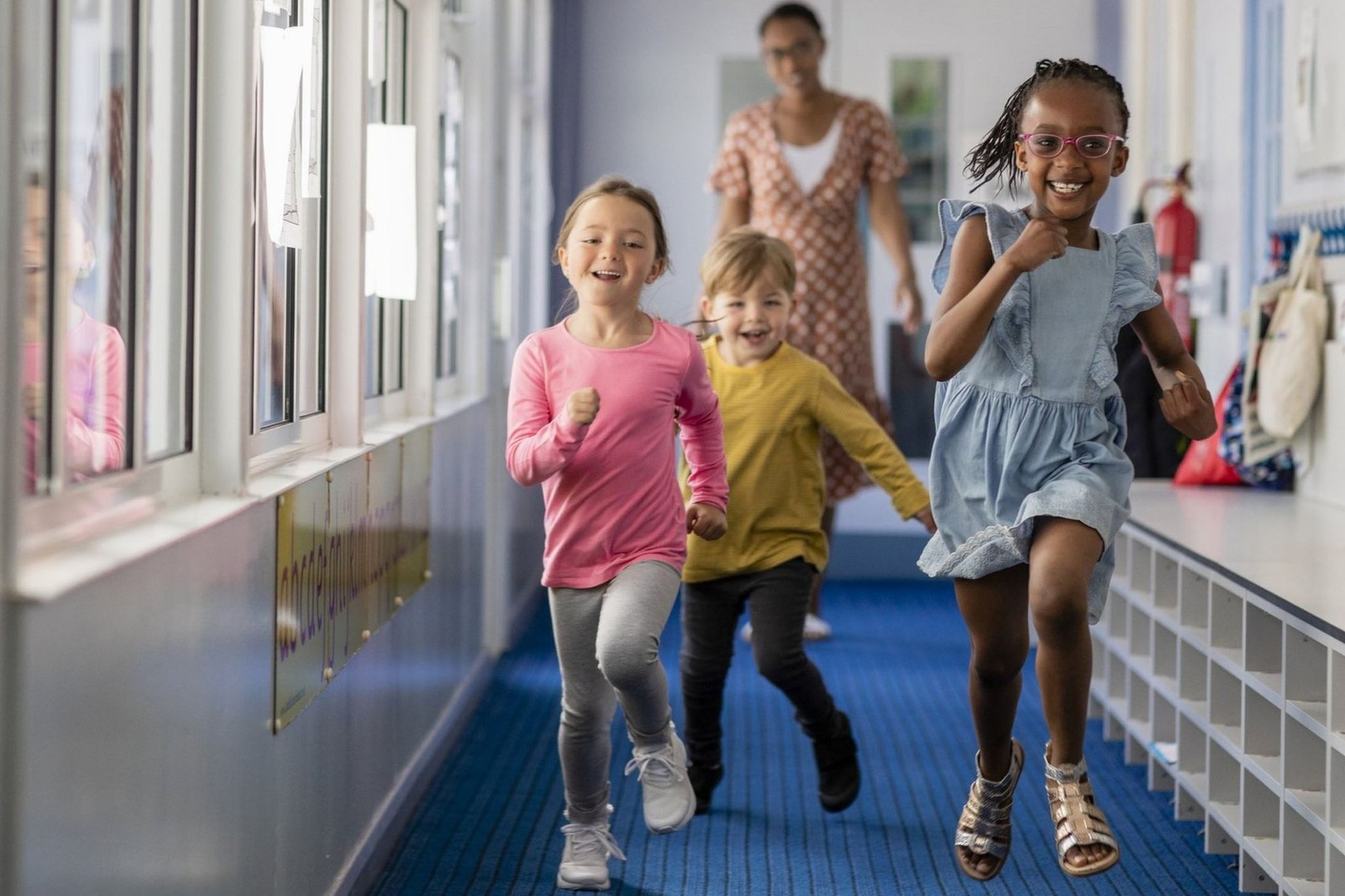 Pre-school children running through a hallway