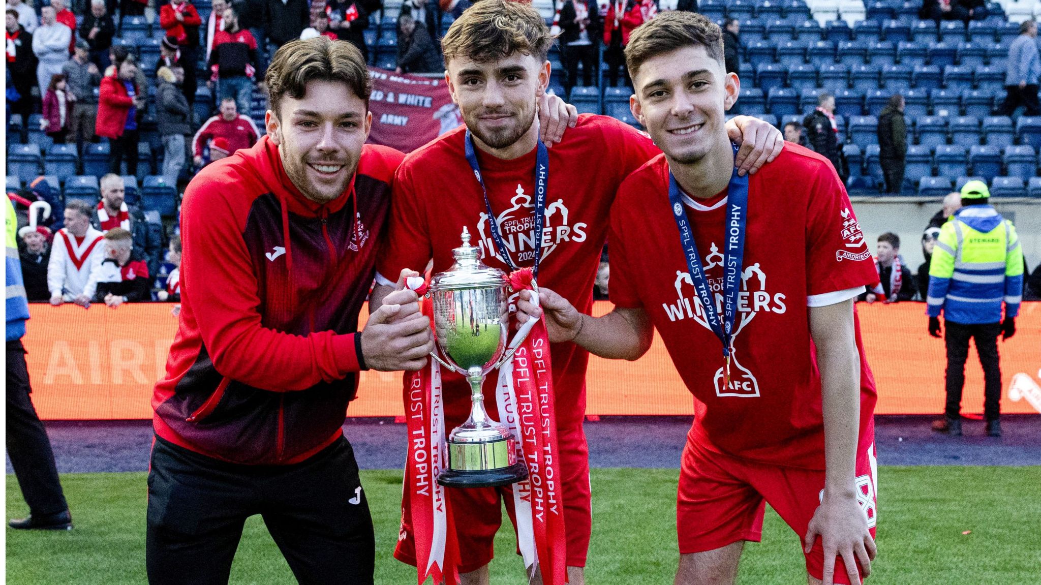 Airdrie's Arron Lyall, Lewis McGregor and Gavin Gallagher celebrate winning the SPFL Trust Trophy
