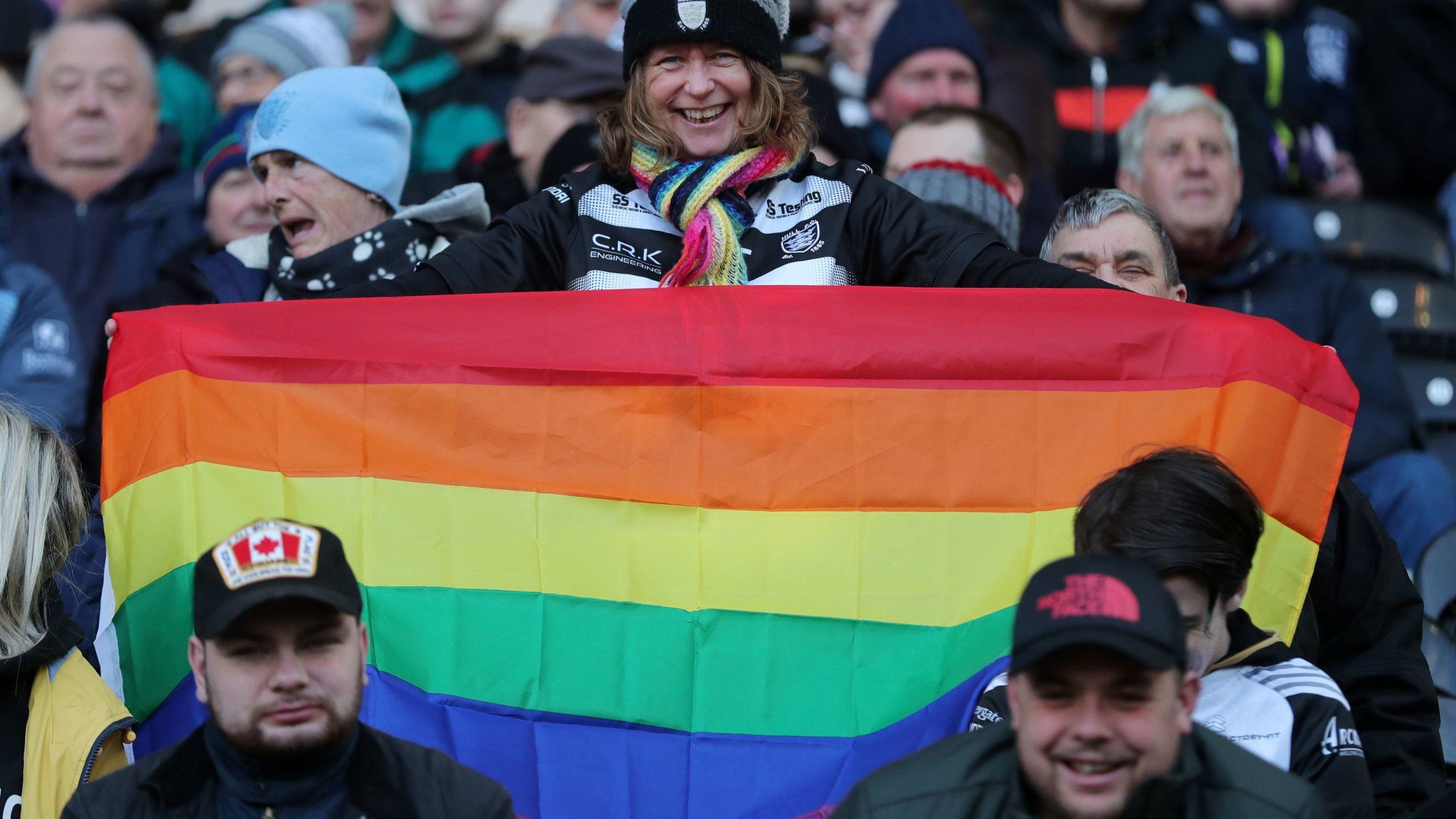 Fan holds up rainbow pride flag at Hull FC's KCOM Stadium for the visit of Catalans Dragons' Israel Folau