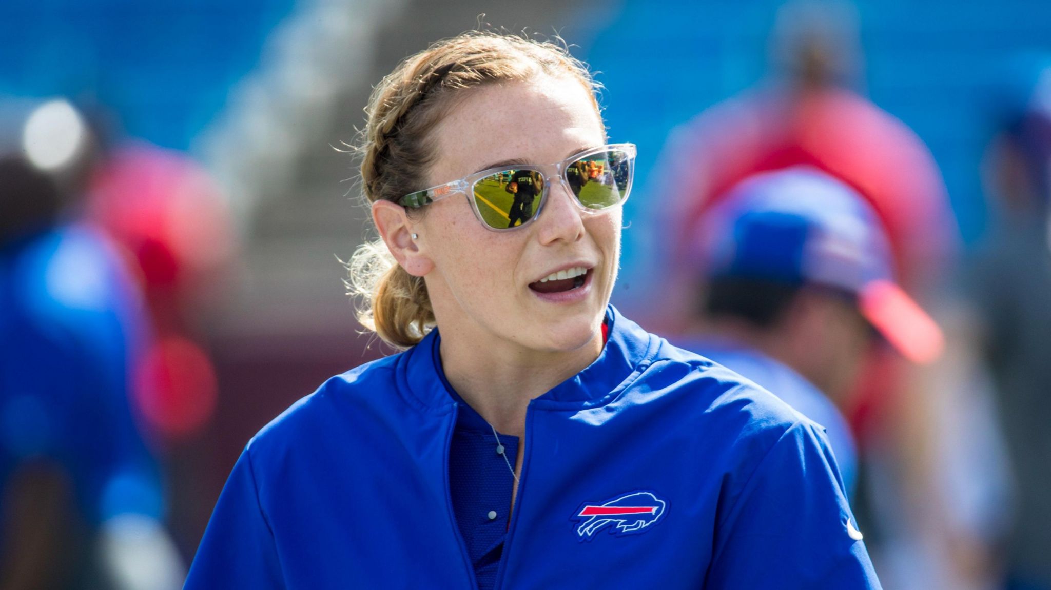 Phoebe Schecter wearing sunglasses and a blue Buffalo Bills jacket