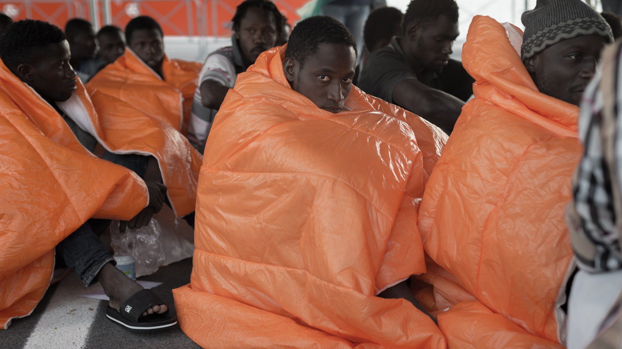 Refugees huddled on ship deck