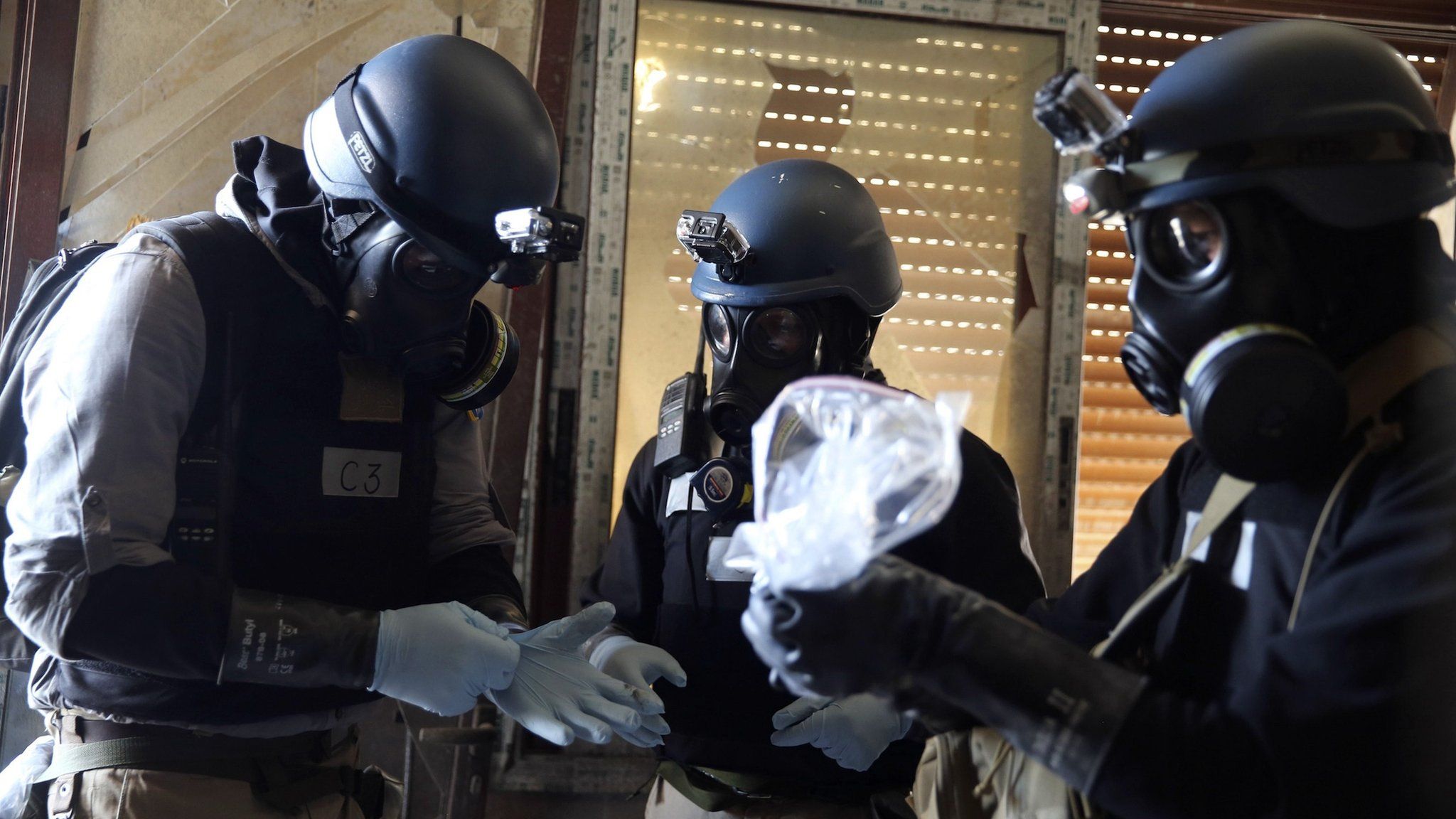 Chemical weapons experts collect samples from the site of an attack in Ain Tarma, Damascus, on 29 August 2013