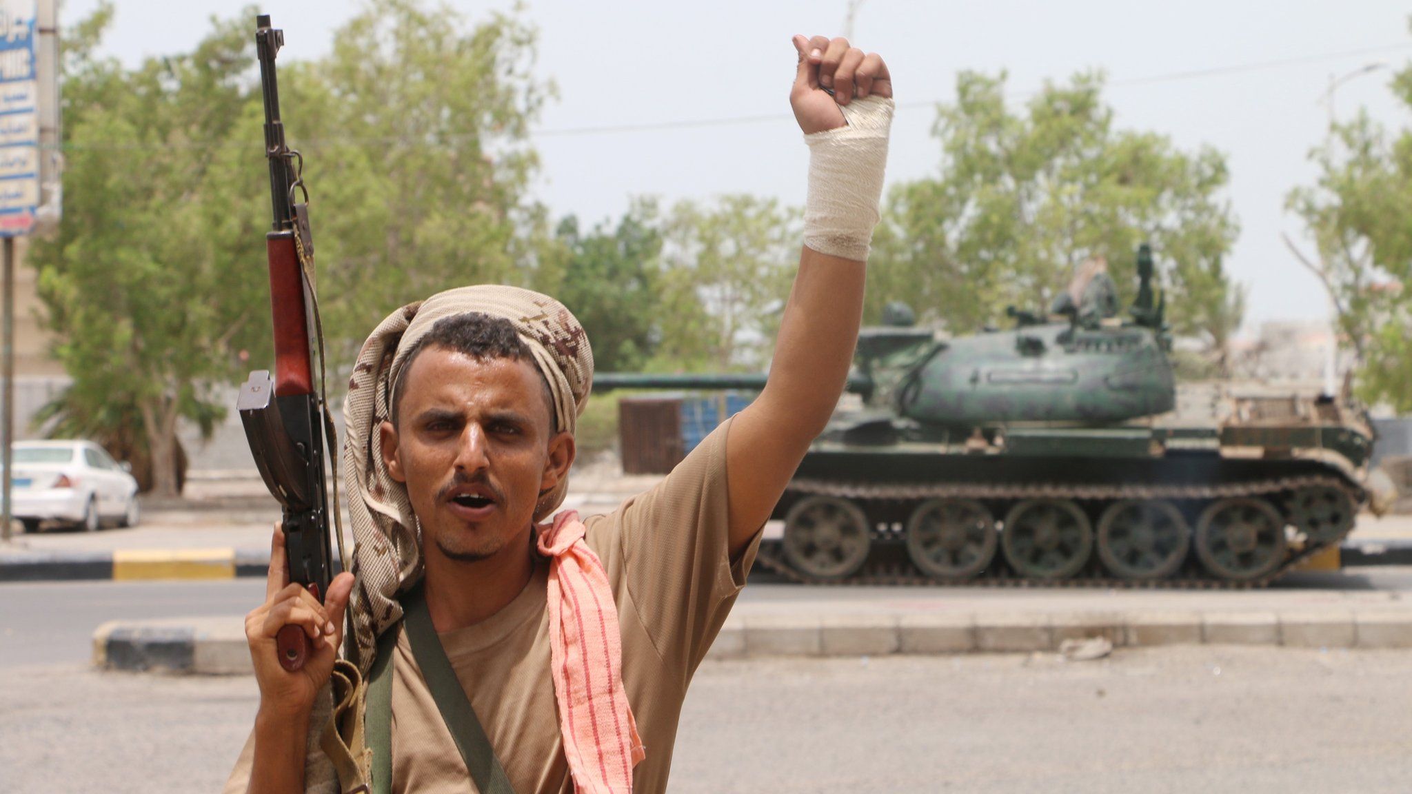 An armed separatist fighter celebrates after seizing a military base during clashes with government forces in Aden on 10 August