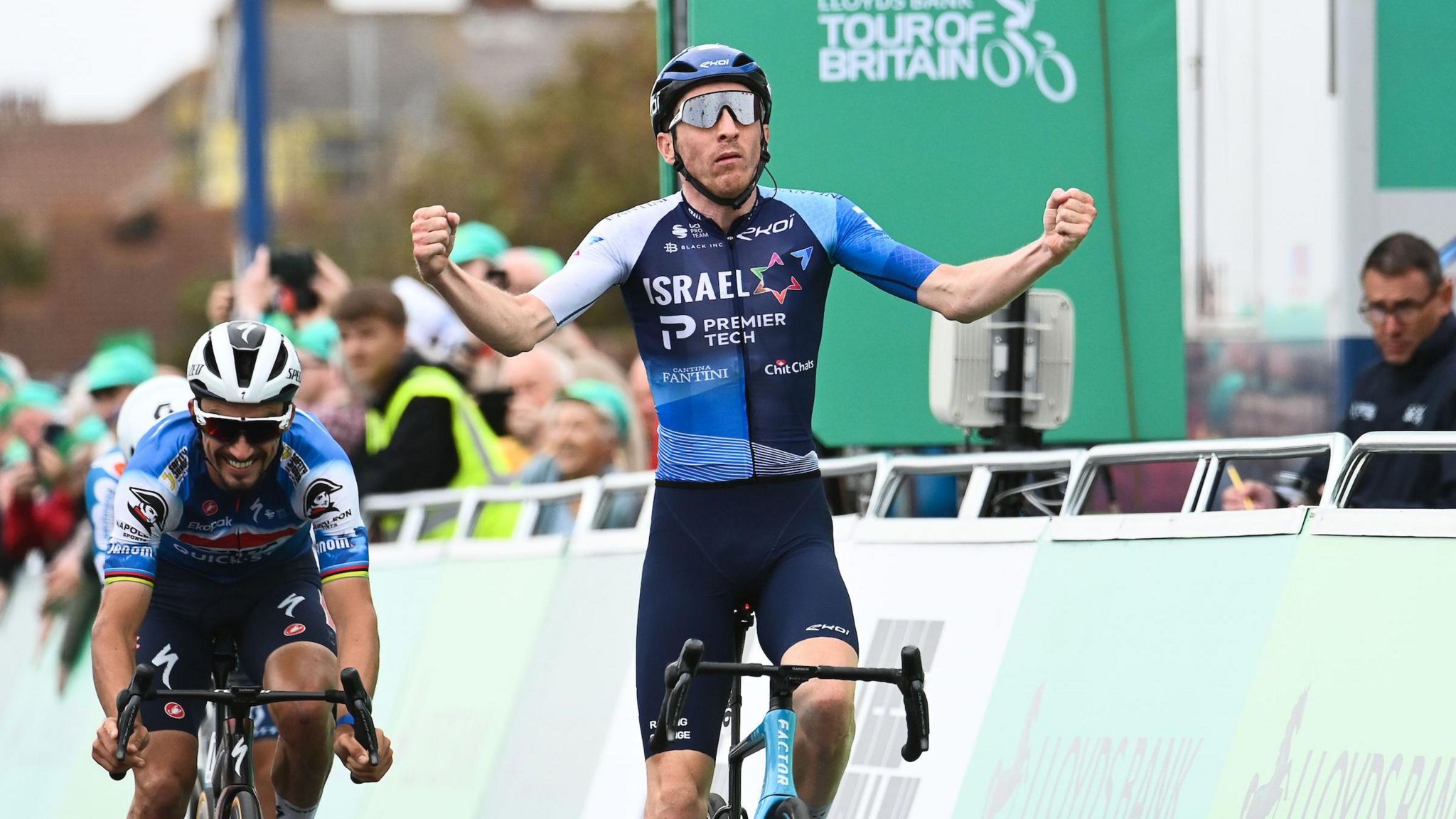 Welsh cyclist Stephen Williams raises his arms in celebration after winning stage two of the 2024 Tour of Britain