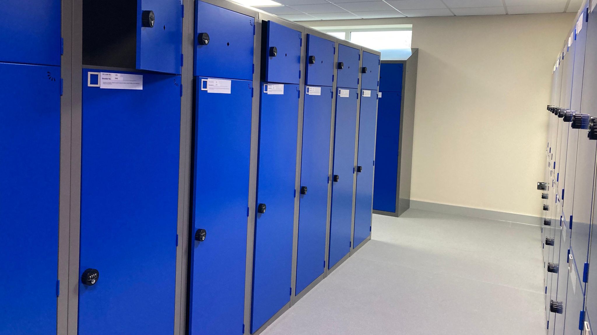 A row of blue full-length lockers