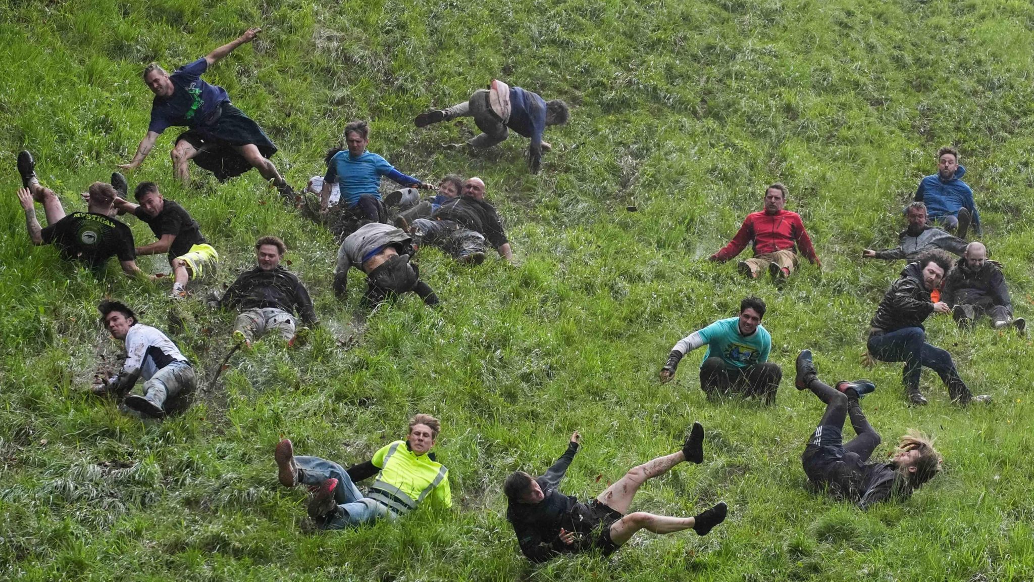 Men tumbling down a hill