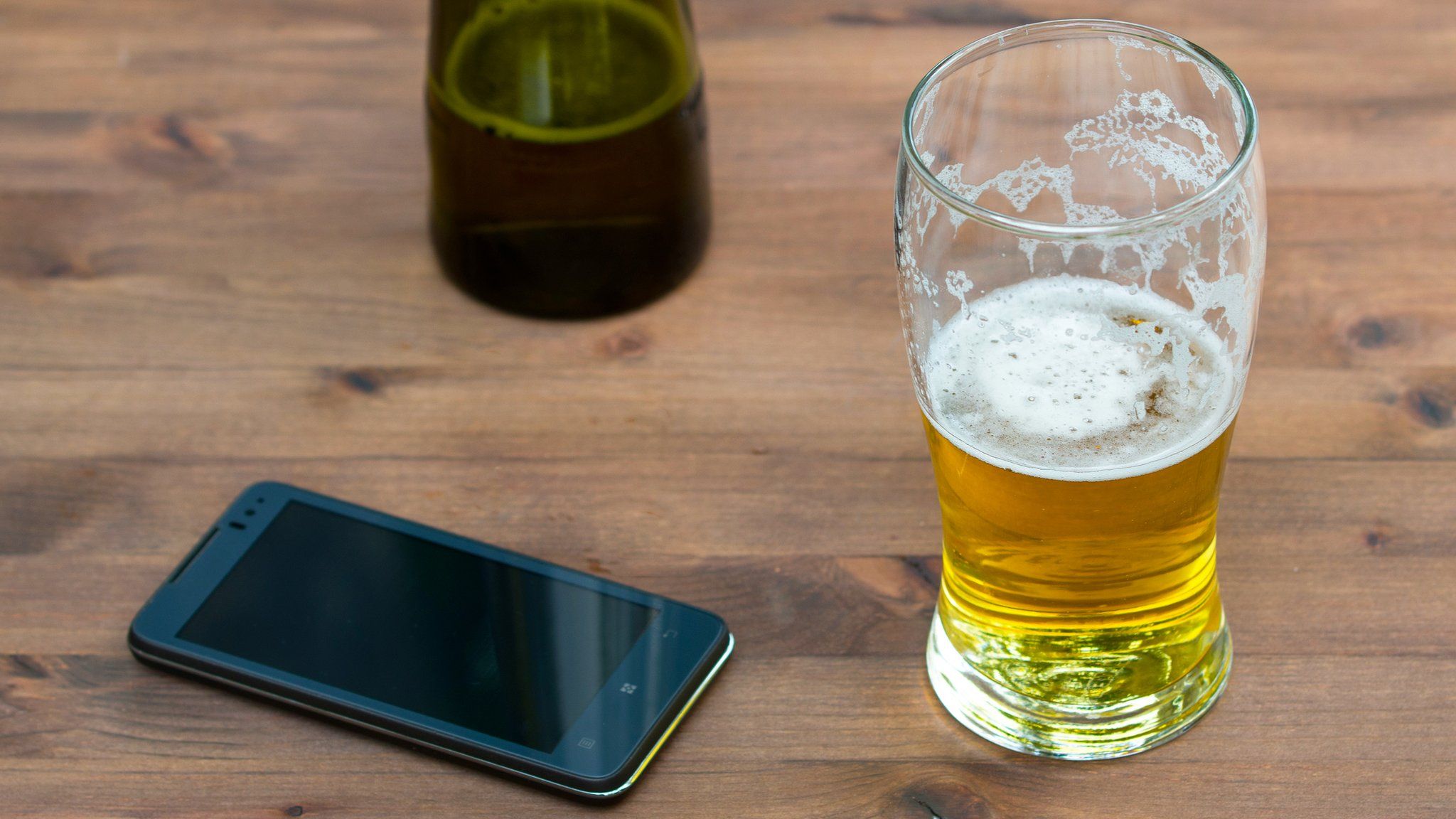A pint glass and smartphone